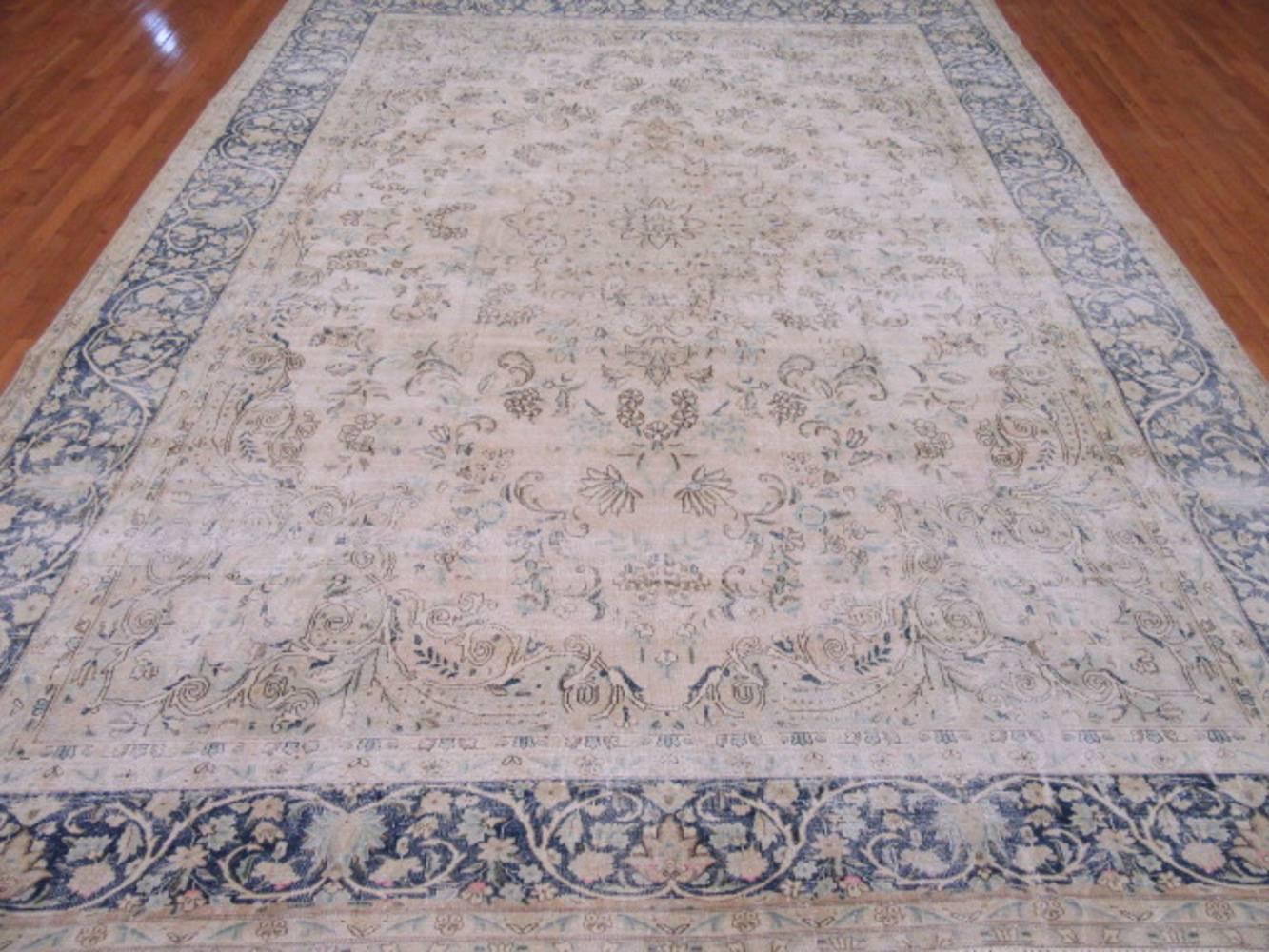This is a beautiful hand-knotted distressed old Persian Kerman rug . It has the cool contemporary and popular colors mixed with a more traditional pattern creating a great transitional rug to work with. It measures 9' 9'' x 13' 1'' and in good shape.