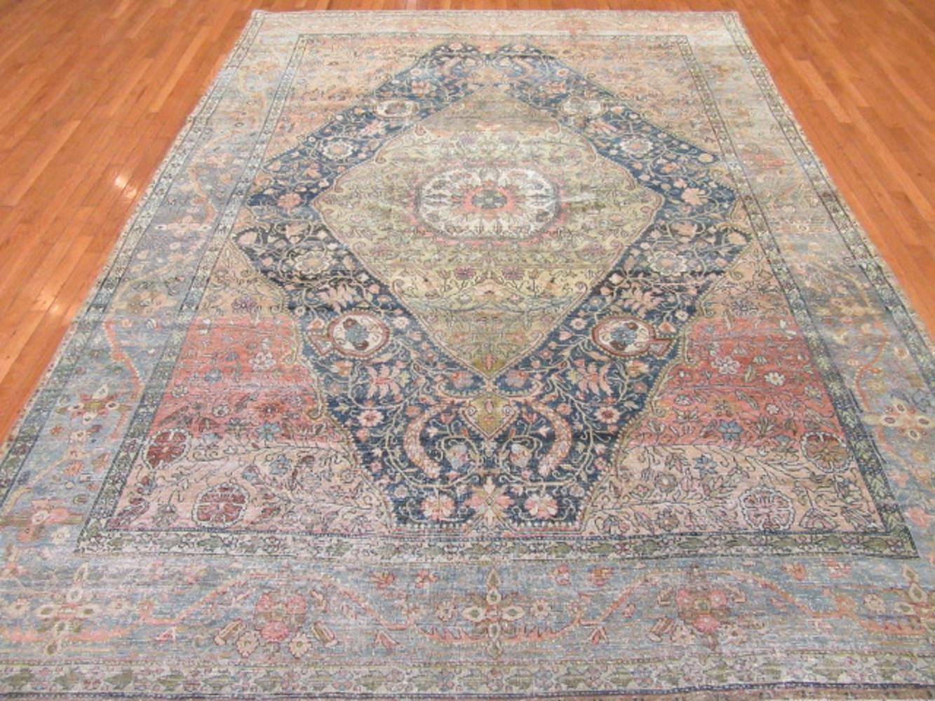 This is a beautiful and unique antique hand-knotted Persian Sarouk Farahan rug with a softer color combination not found in these type of rugs very much. It would enhance the look of any room. It measures 8' x 10' 7’’. It is in great condition and