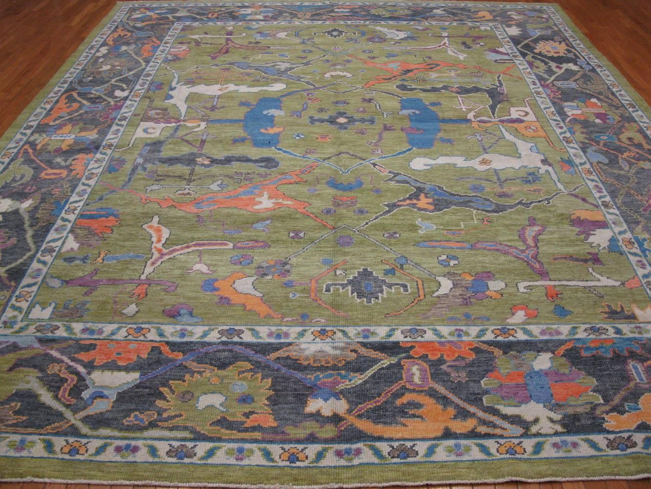 This is a new handmade Turkish Oushak rug with fresh and bright colors recapturing the look of the antique Oushak’s of the early 20th century.  It is made with all wool and natural dyes. It measures 10' 11'' x 13' 6''.