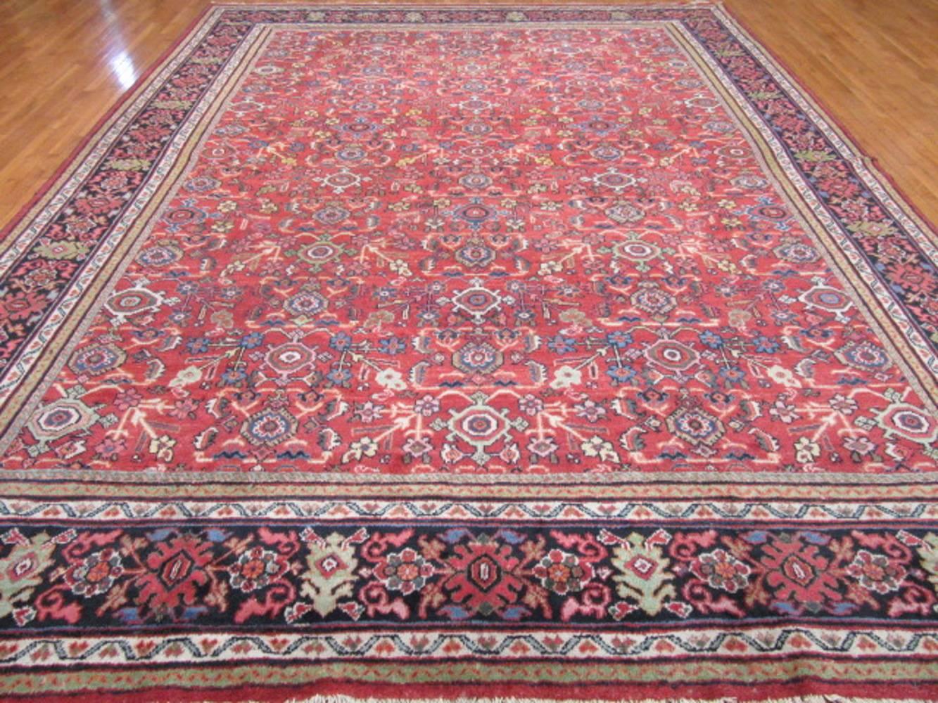 This is an antique Persian Mahal rug with an all-over pattern hand-knotted with wool colored with all natural dyes. Mahal rugs have been a sought after type of rug from the western mountain region of Iran. Antique Mahals are very easy rugs to work