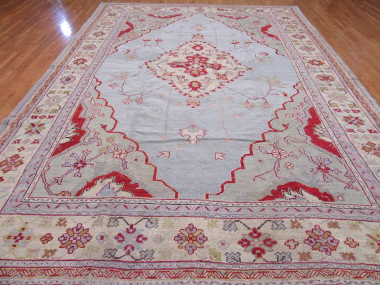 This early 20th century antique Turkish Oushak rug has an unusual and hard to find color combination. The rug is made with wool that is colored with natural dyes. A flexible rug that can work in just about any setting and any room. It measures 11'