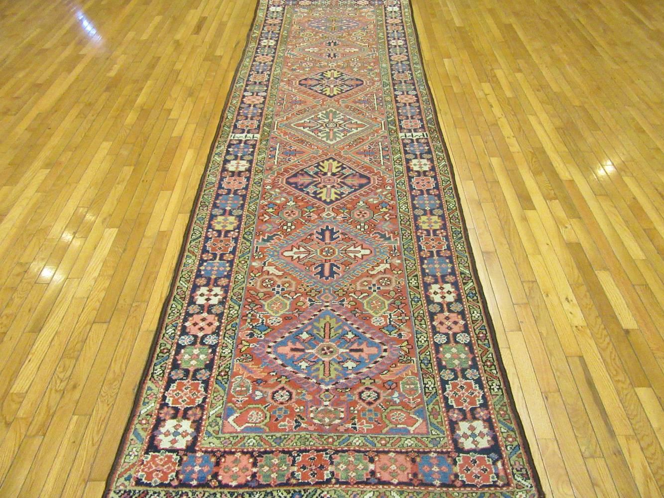 This is a hand-knotted antique genuine Persian Heriz runner rug. It has the colors and design that has made Heriz rugs a much sought after and popular rugs. It has a date inscribed in the border indicating it was made in 1904 AD (1322 Hijri). It