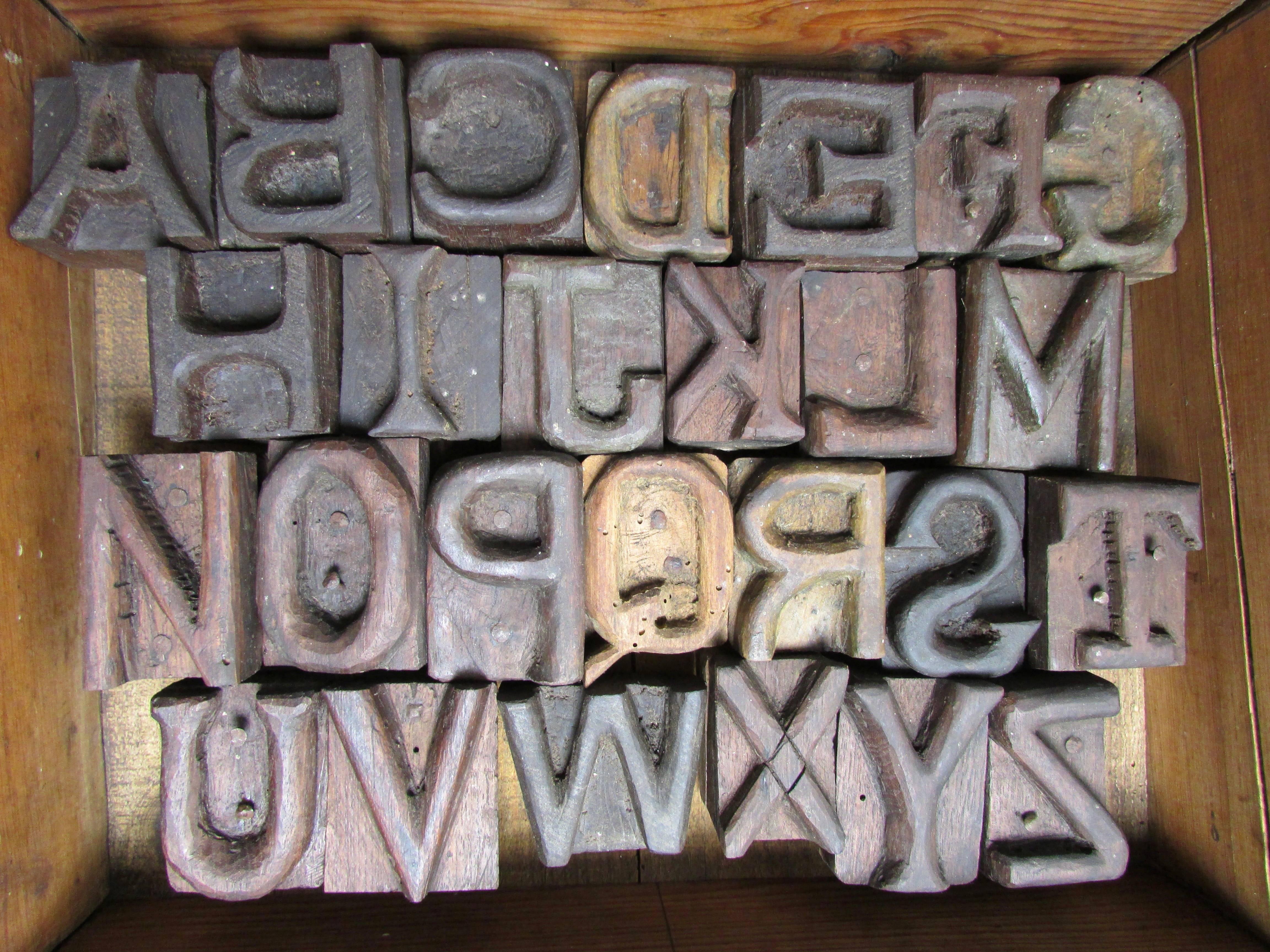 This is one of a kind set of hand-carved alphabet wood block letters from a grave stone factory in Arkansas. These were used as a tool to impress letters onto concrete grave stones. Wood blocks are not affixed to the box and vary in size from 1.75