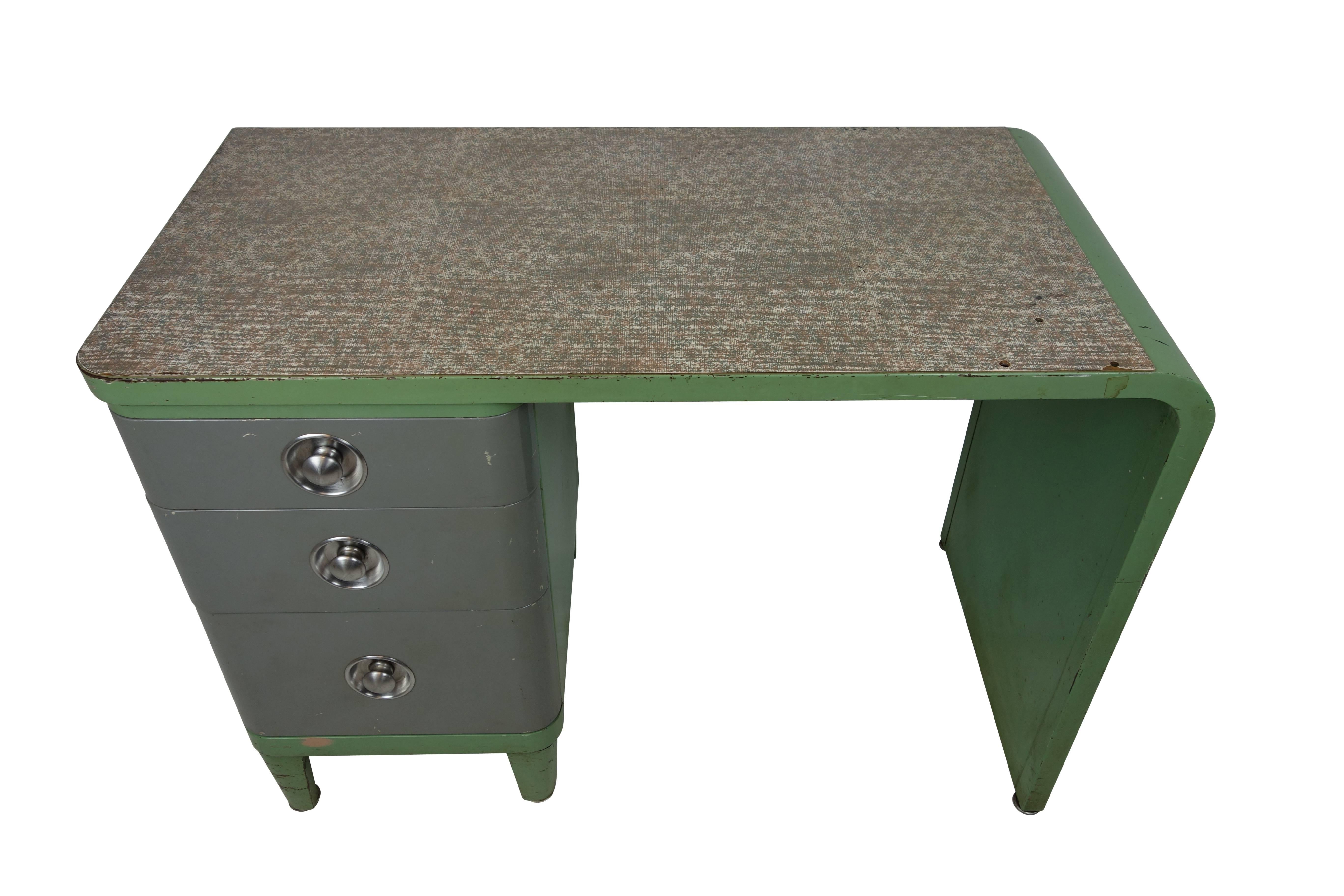 This is an Art Deco Simmons Company Furniture enameled steel desk, designed by Norman Bel Geddes, circa 1930.