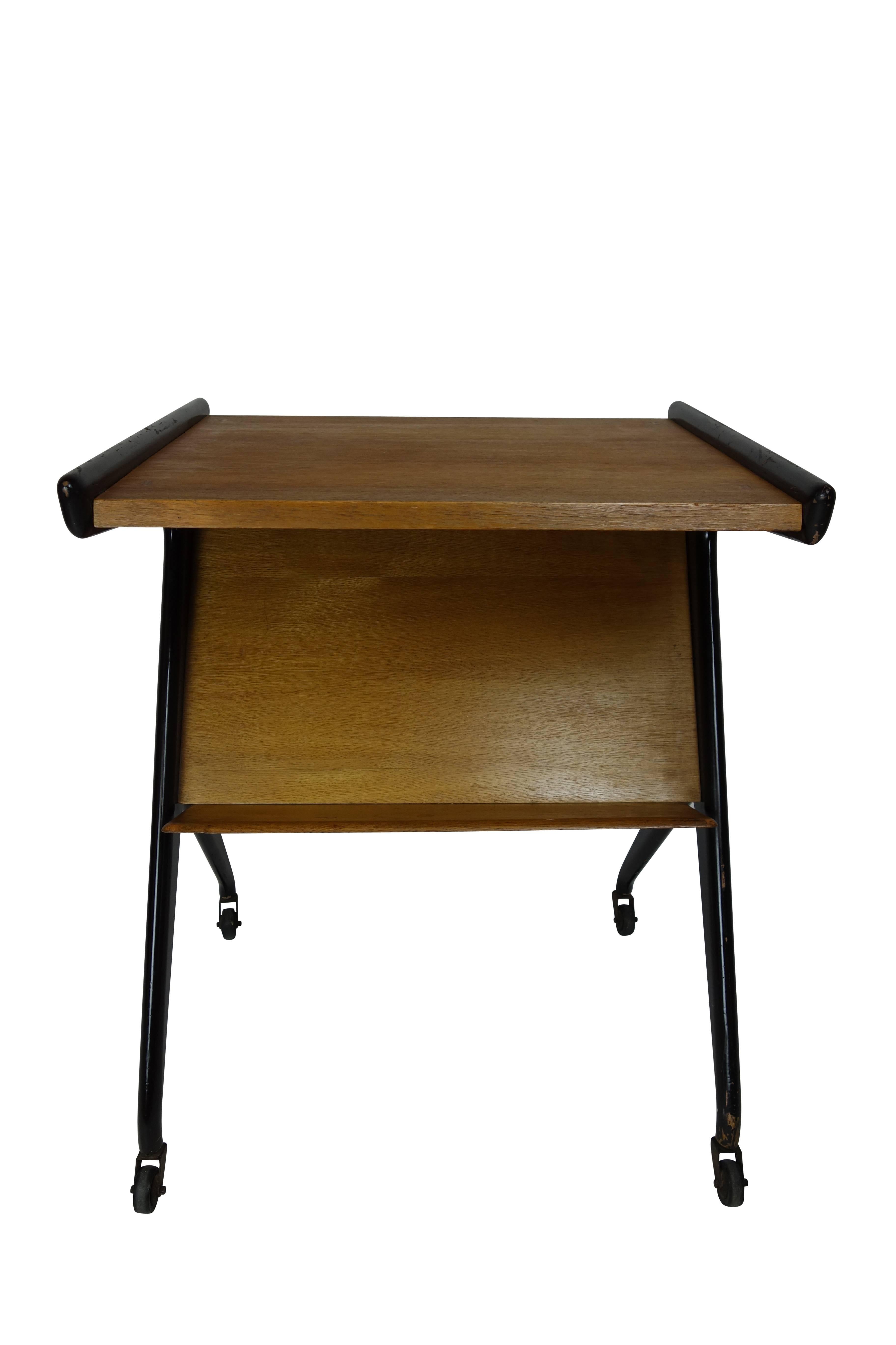 This is an atomic era French Teleavia occasional table on casters, originally designed for a television set, circa 1950.