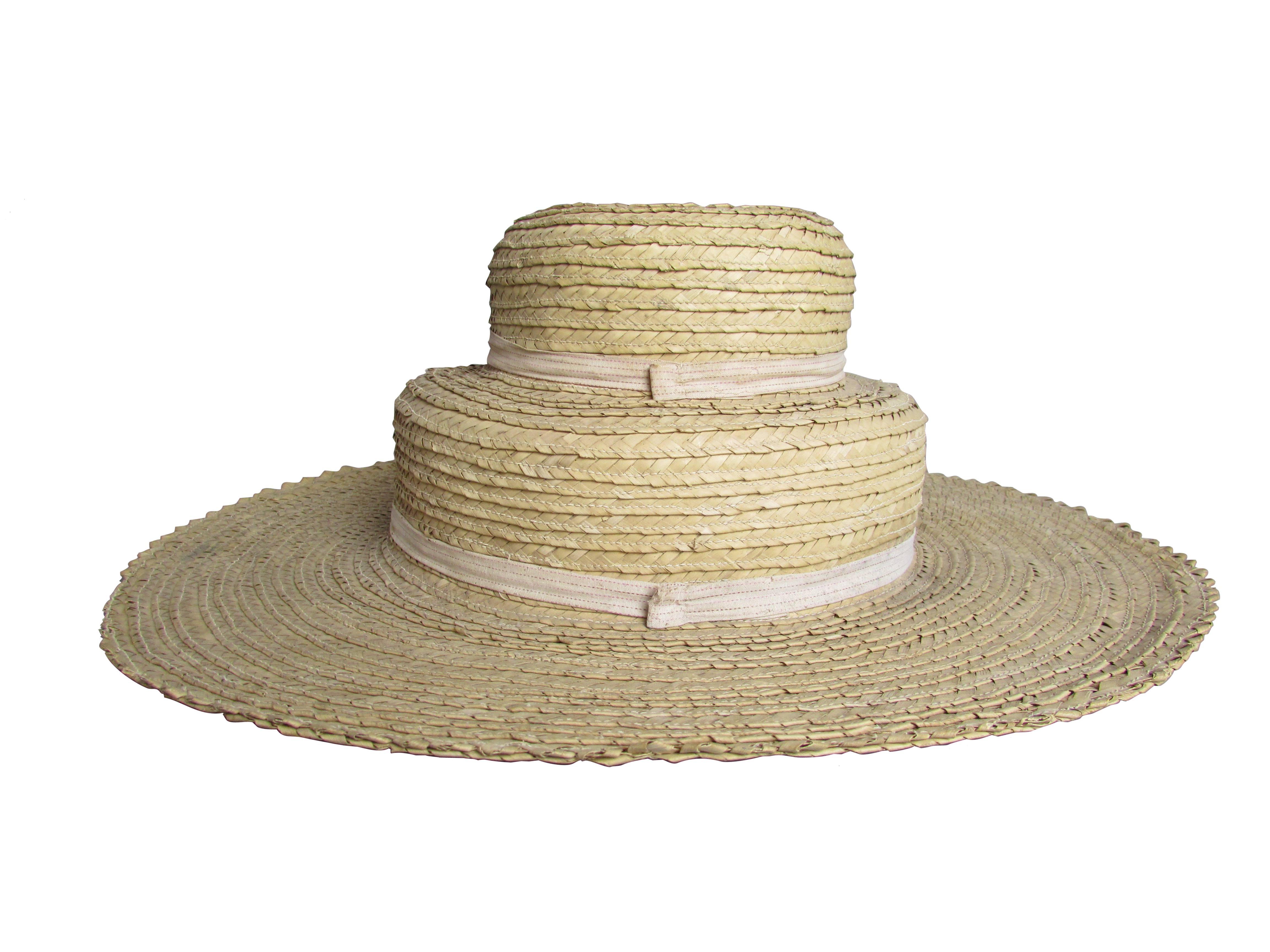 This is an unusual handmade two-tiered shaker hat. The underside of the hat is uniquely constructed with a linen wrapped headband and spacers.