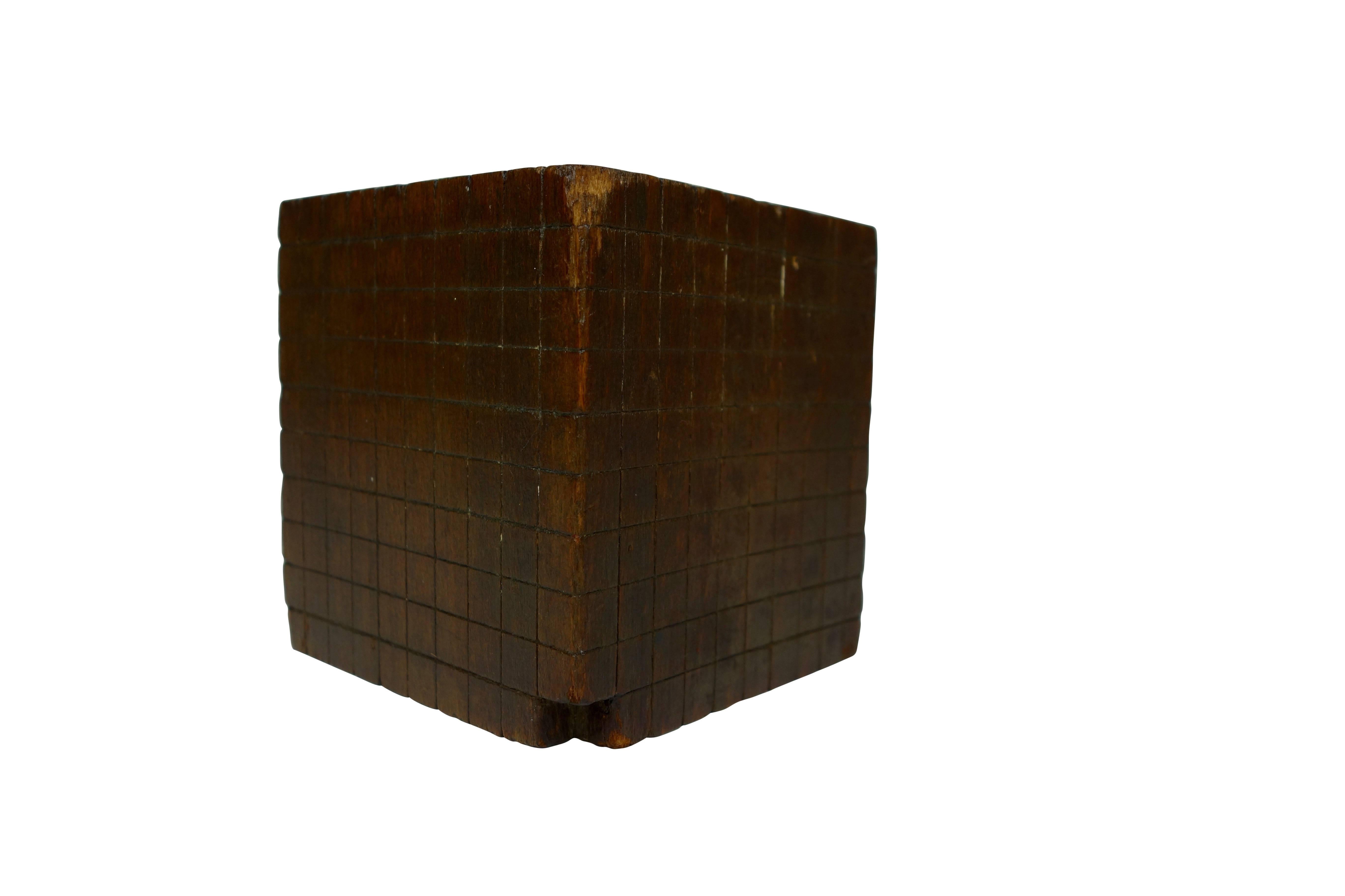 This is an early hand-carved wood "base ten" cube mathematical education model.