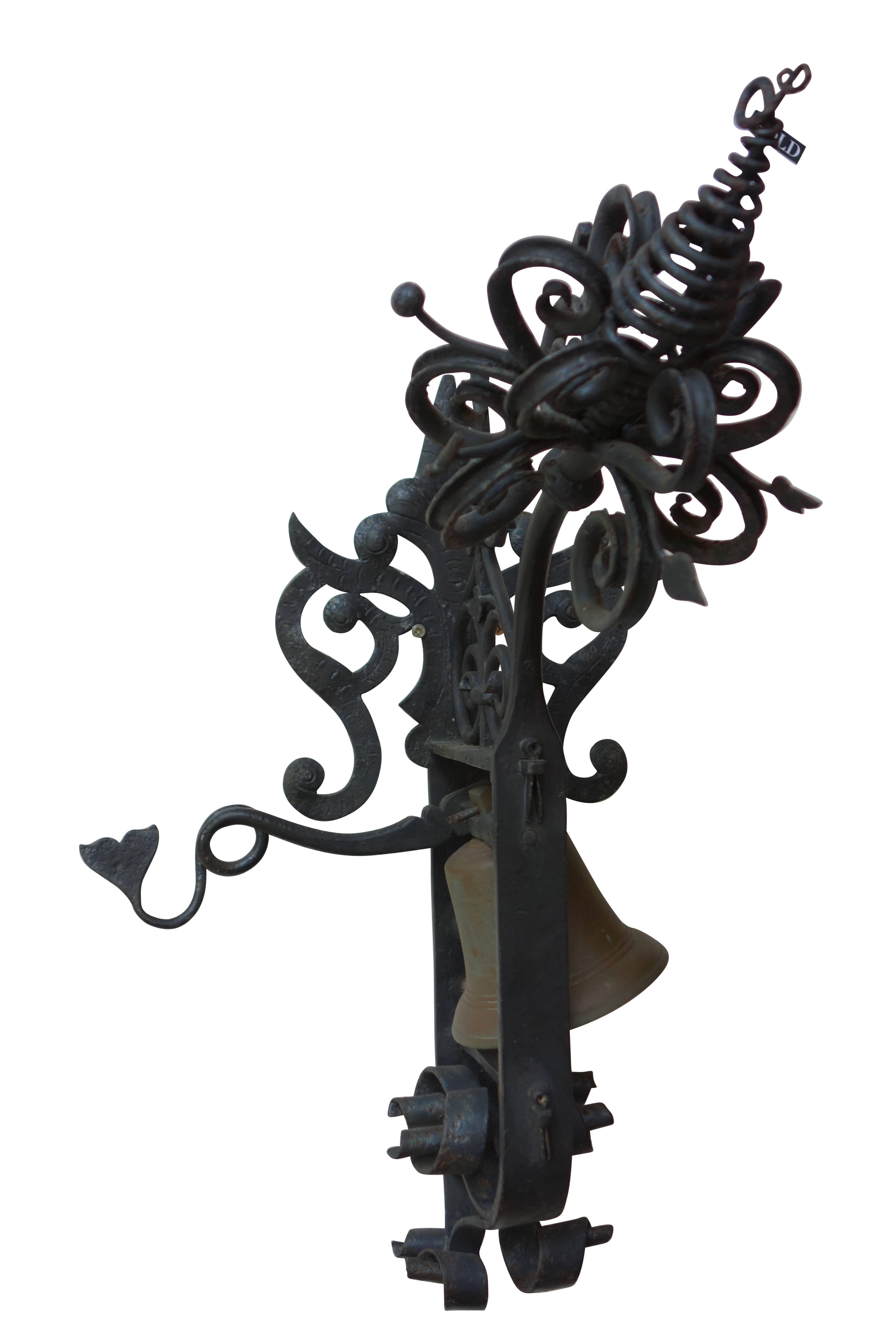 This is a Spanish revival hand-wrought iron garden gate bell with a large ornate flower on the front. The bell is made of brass, and can be rung, quite loudly, by moving the handle up and down.

Measures: Width at wall/base 8.25