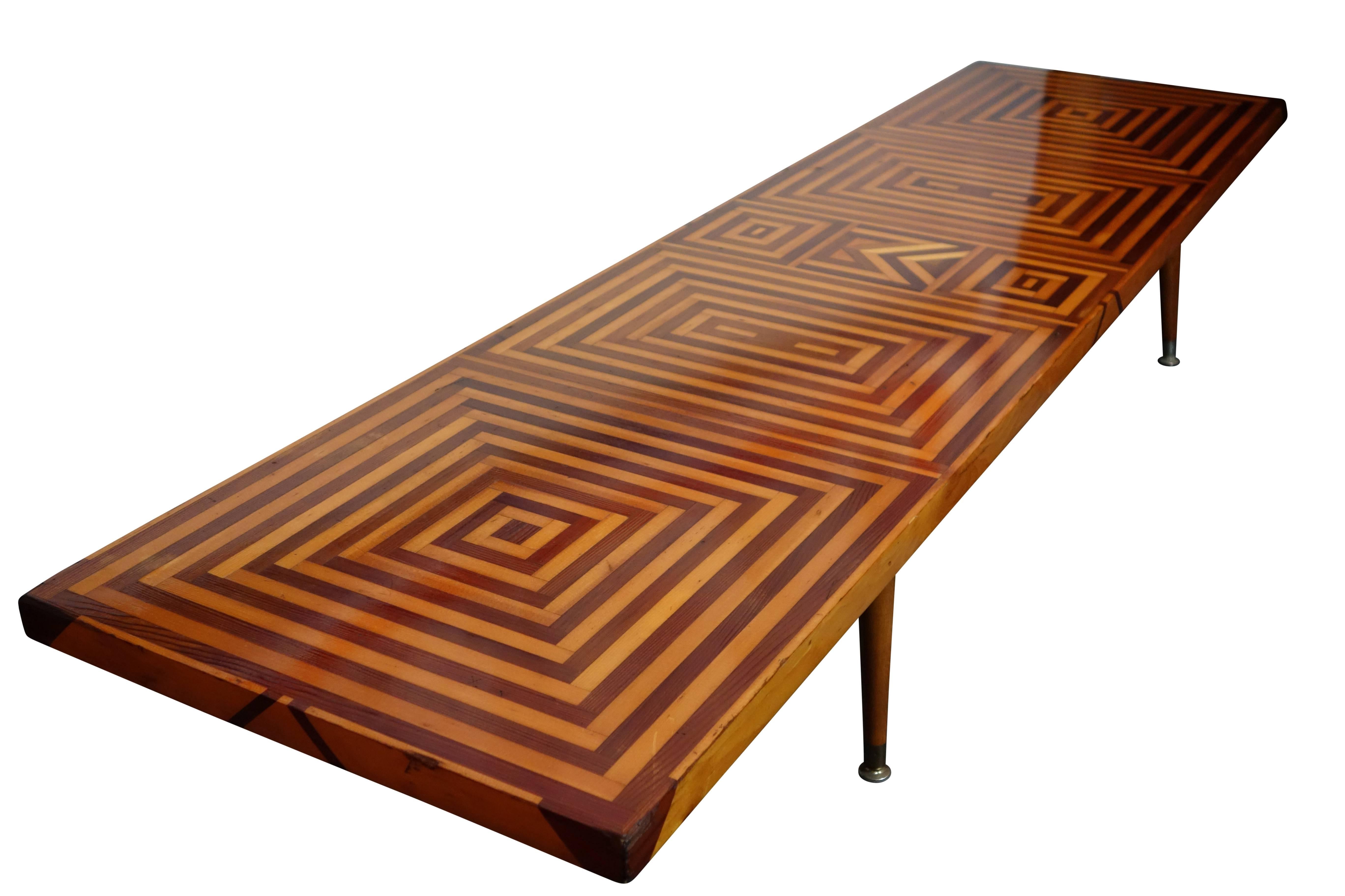 This is a fantastic Mid-Century inlaid walnut and maple coffee table. On the underside of the table, the hardware that attaches the legs has two options, one sets them at an angle, and the other sets them straight.