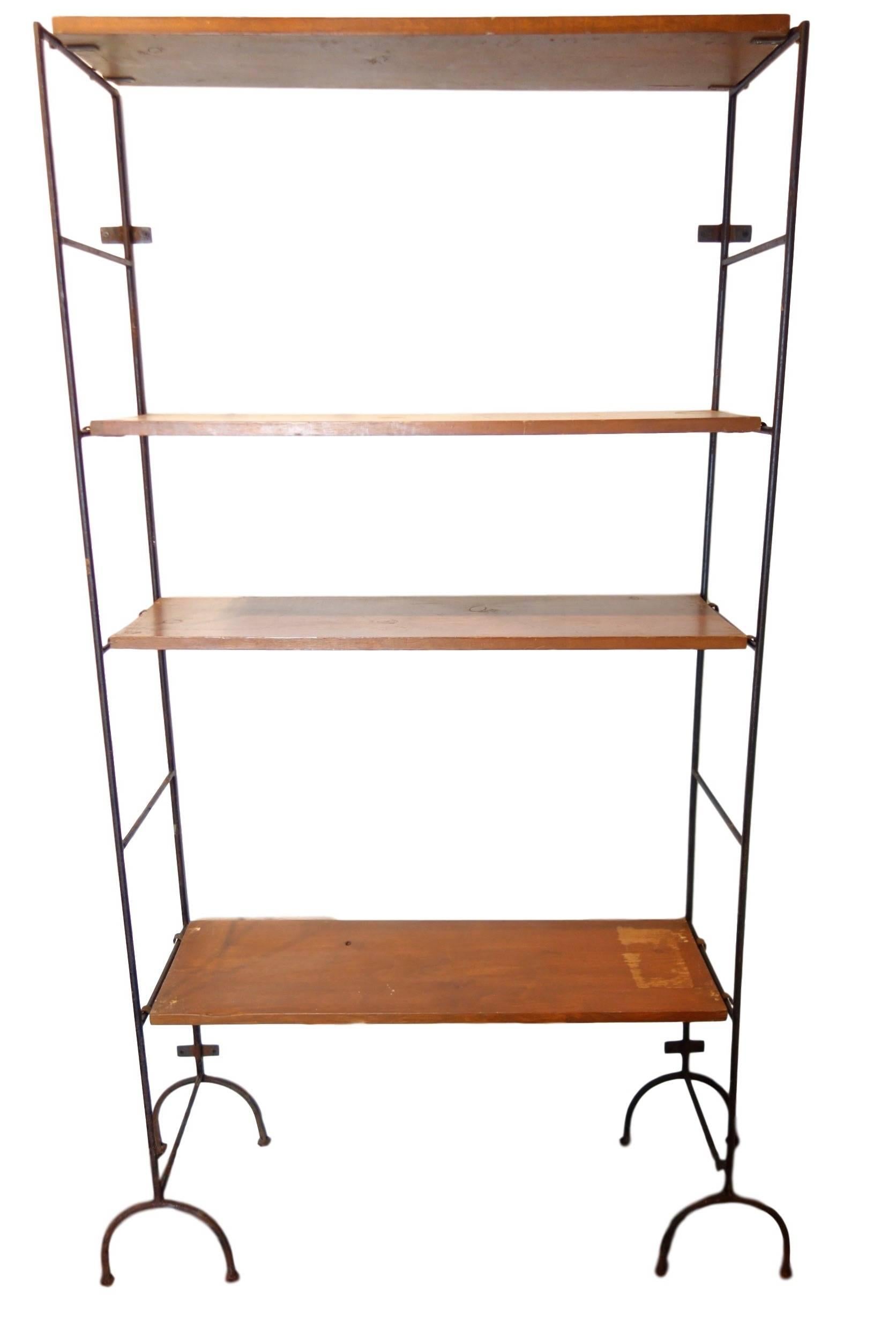 This is a pair of iron and wood modular shelves with unique Curule legs. Hardware on the backside of the frame secure the shelves to the wall. Each shelf has iron hardware on the ends allowing you to adjust the shelves to the desired height. 

  