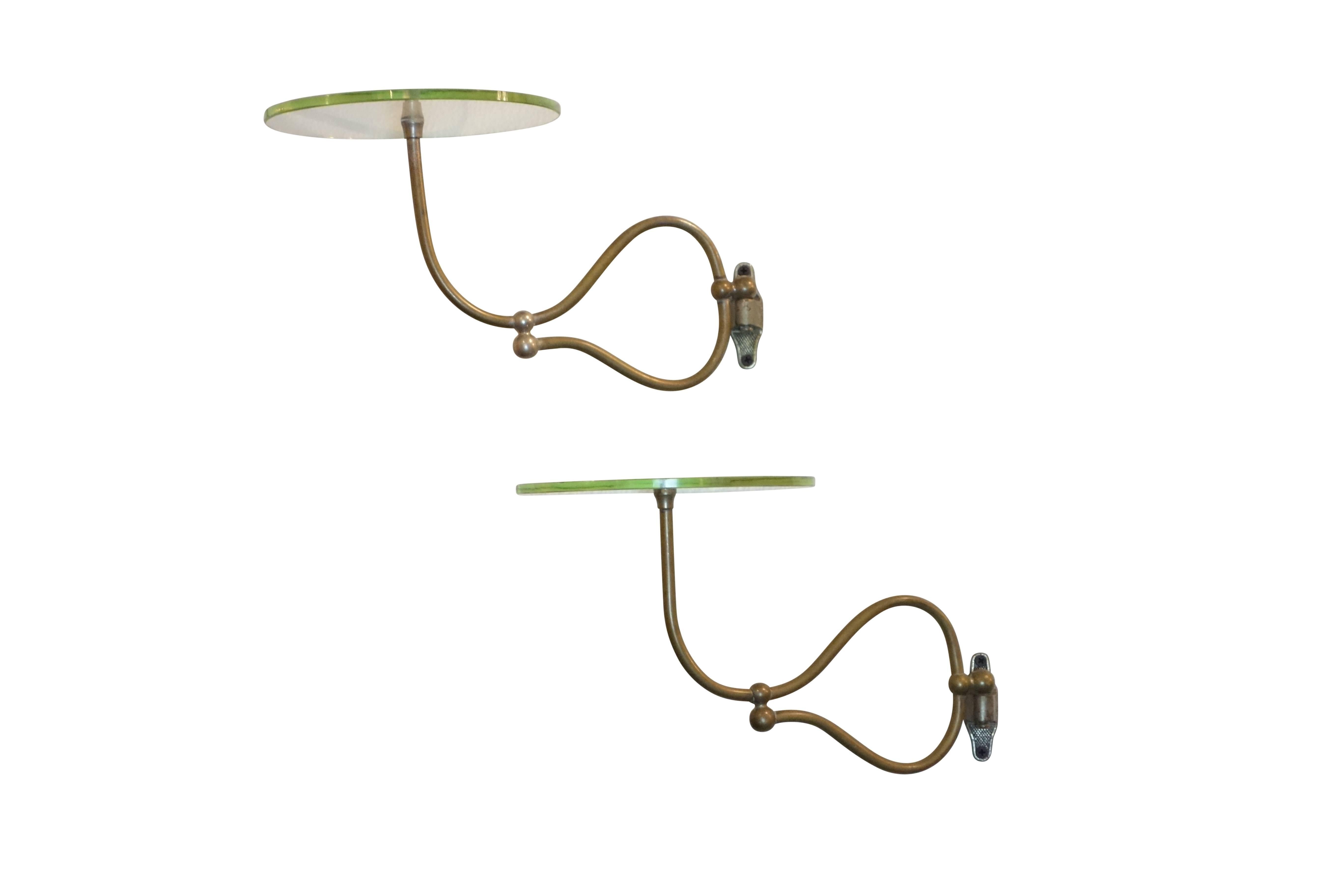 This is a fantastic pair of circular articulating wall mount shelves with nickel plated brass hardware, circa 1920. Glass plates are 8 inches in diameter. 

 