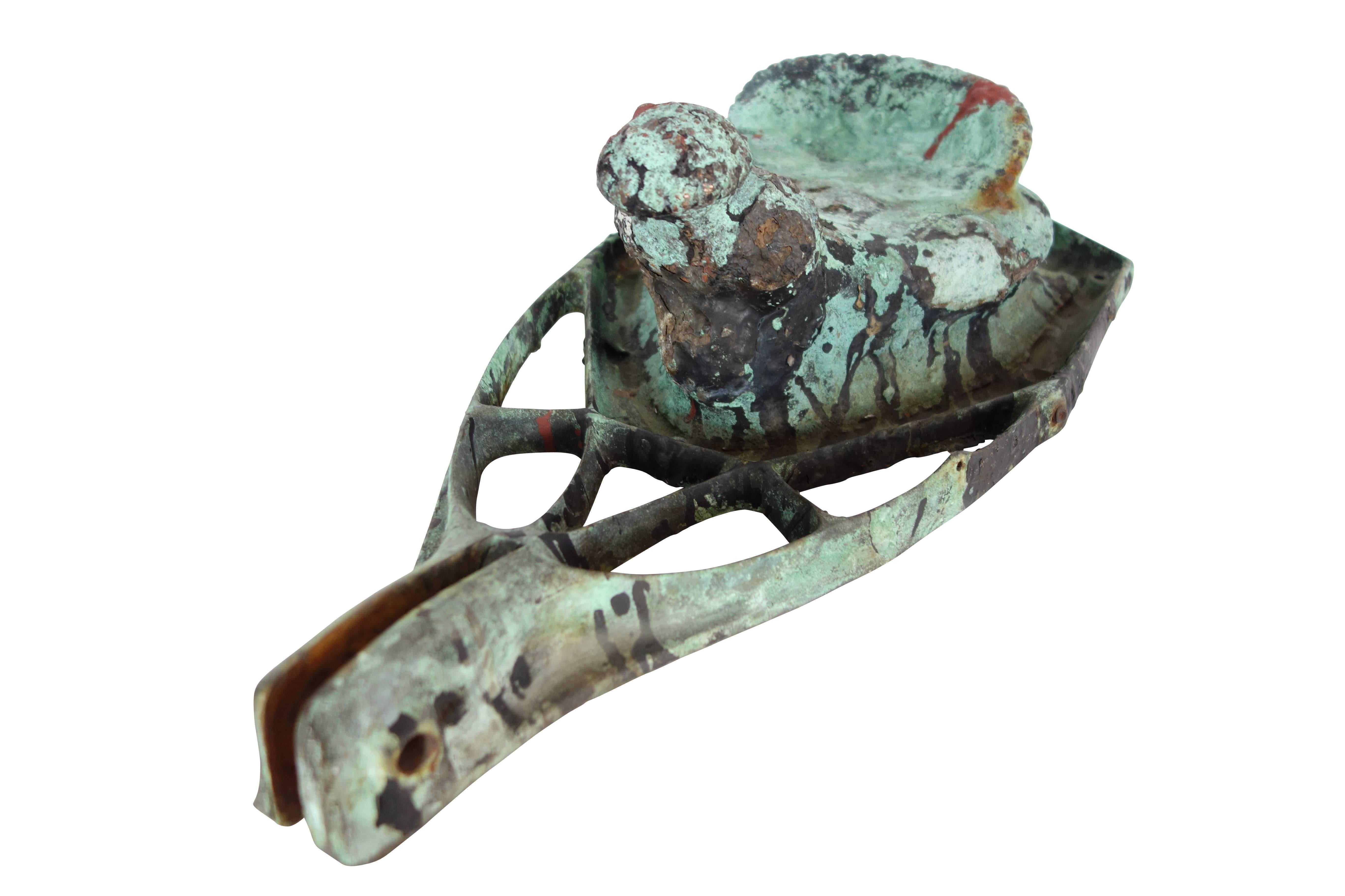 This is a bronze mold of a child’s saddle-shaped bike seat cover with western themed impression on underside.