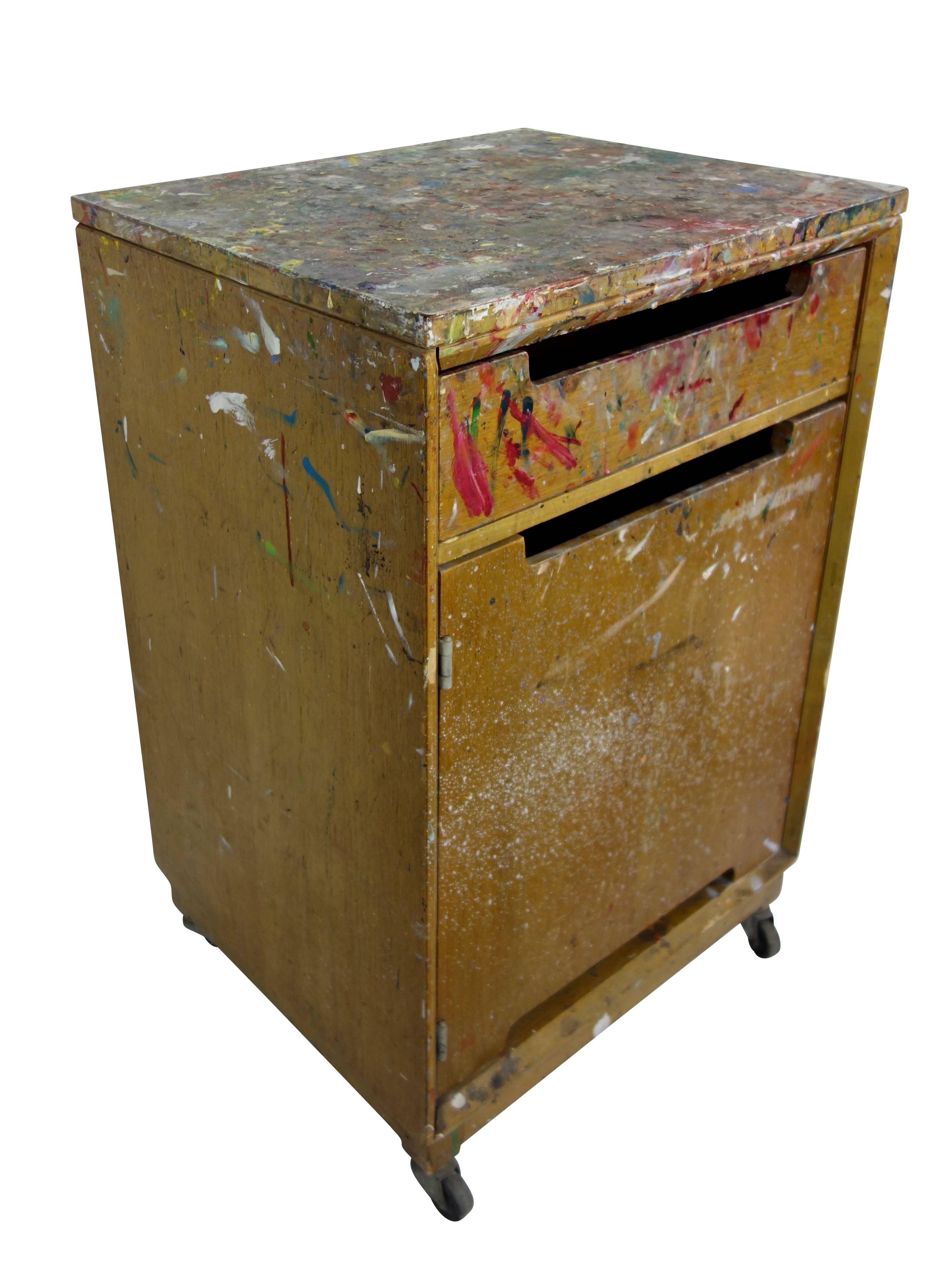 This is a neat paint splattered cabinet on casters from an artist's studio.