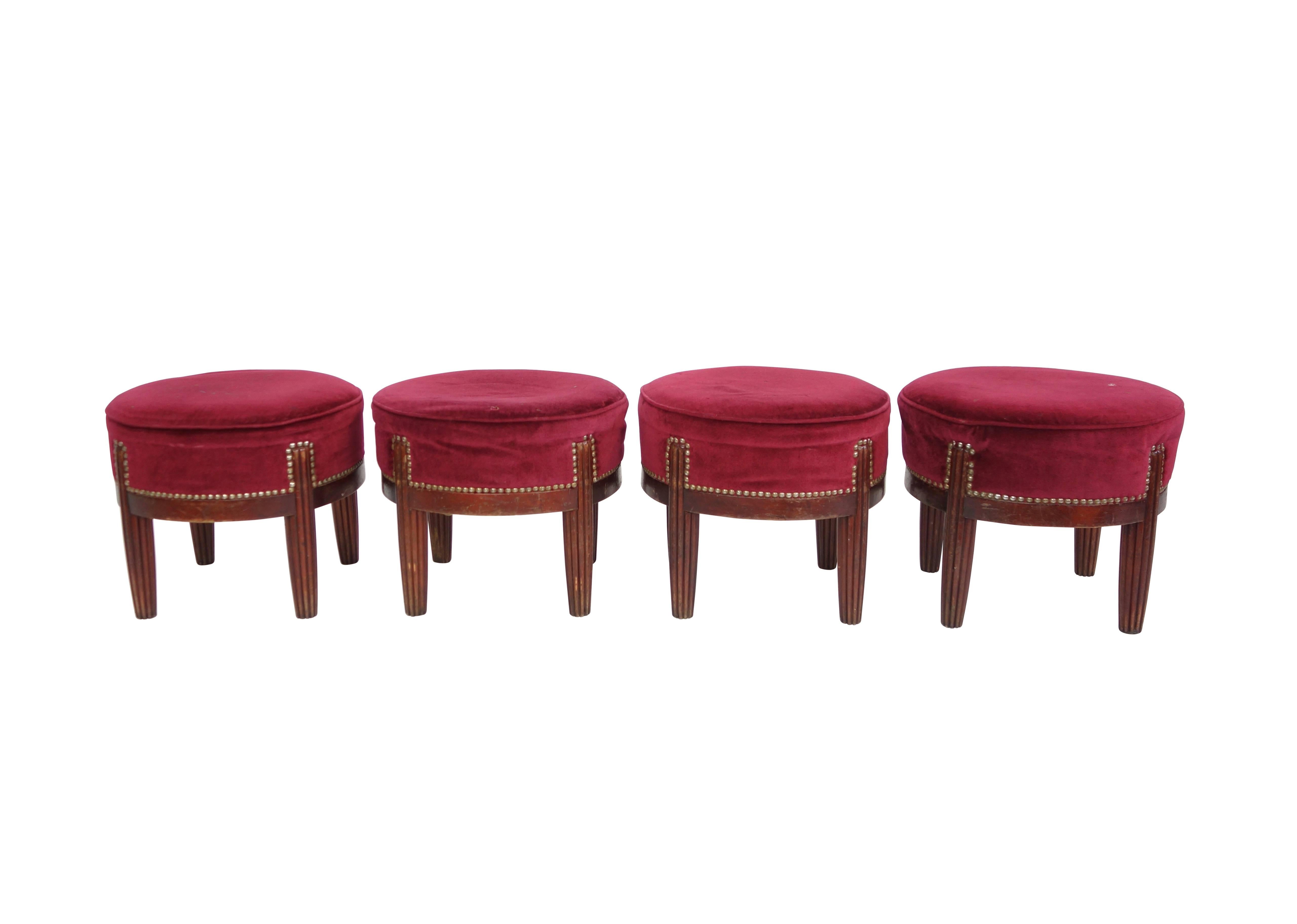 This is a petite riveted red velvet footstool from France, circa 1930. Four available, sold individually.