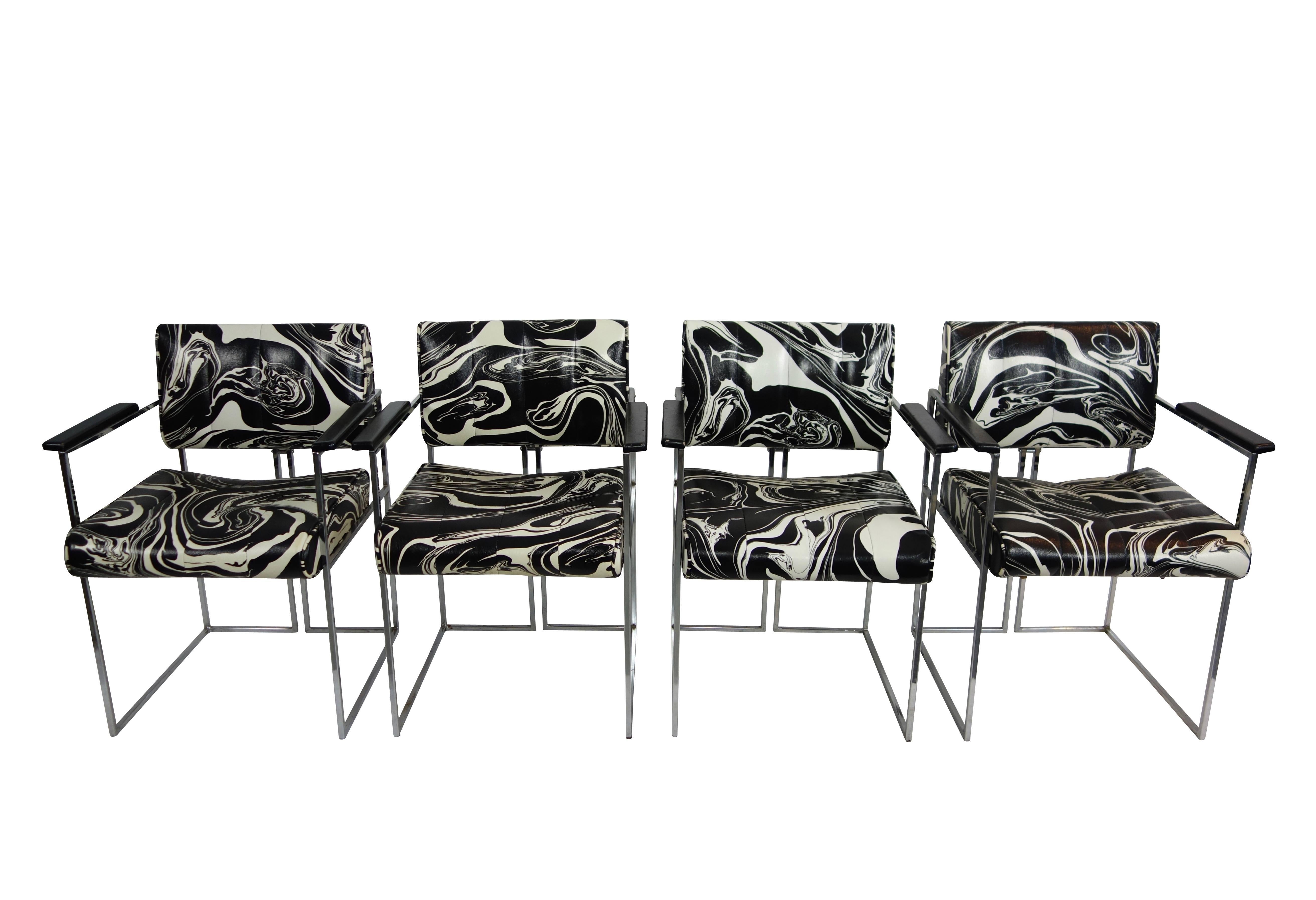 This is a set of four vintage black and white marbled vinyl chairs with sleek chrome frames by Samton. The original labels are intact on the underside of the chairs. Made in Canada.