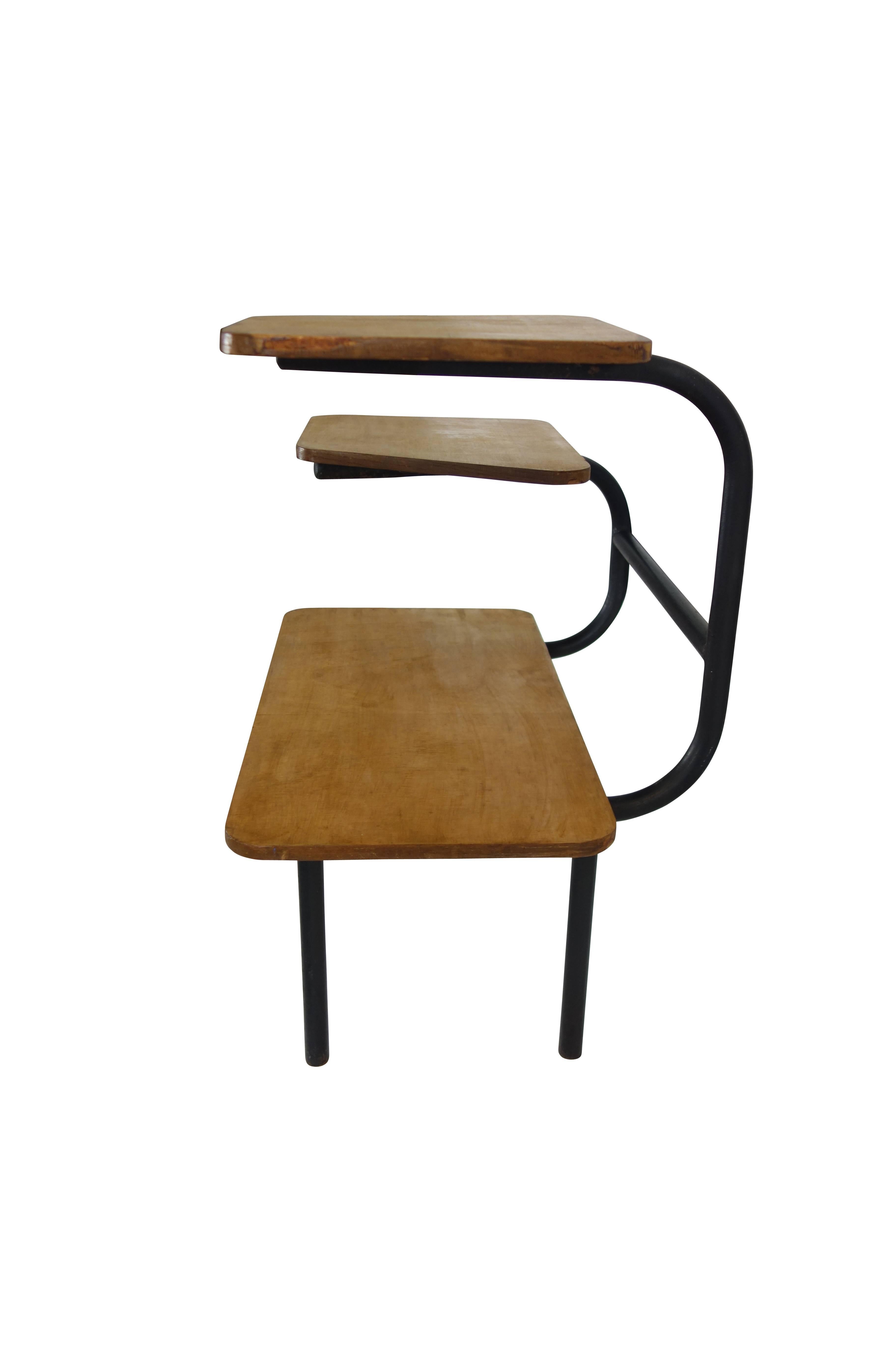 This is a unique Bauhaus style tubular steel and wood three tiered side table from France, circa 1940.