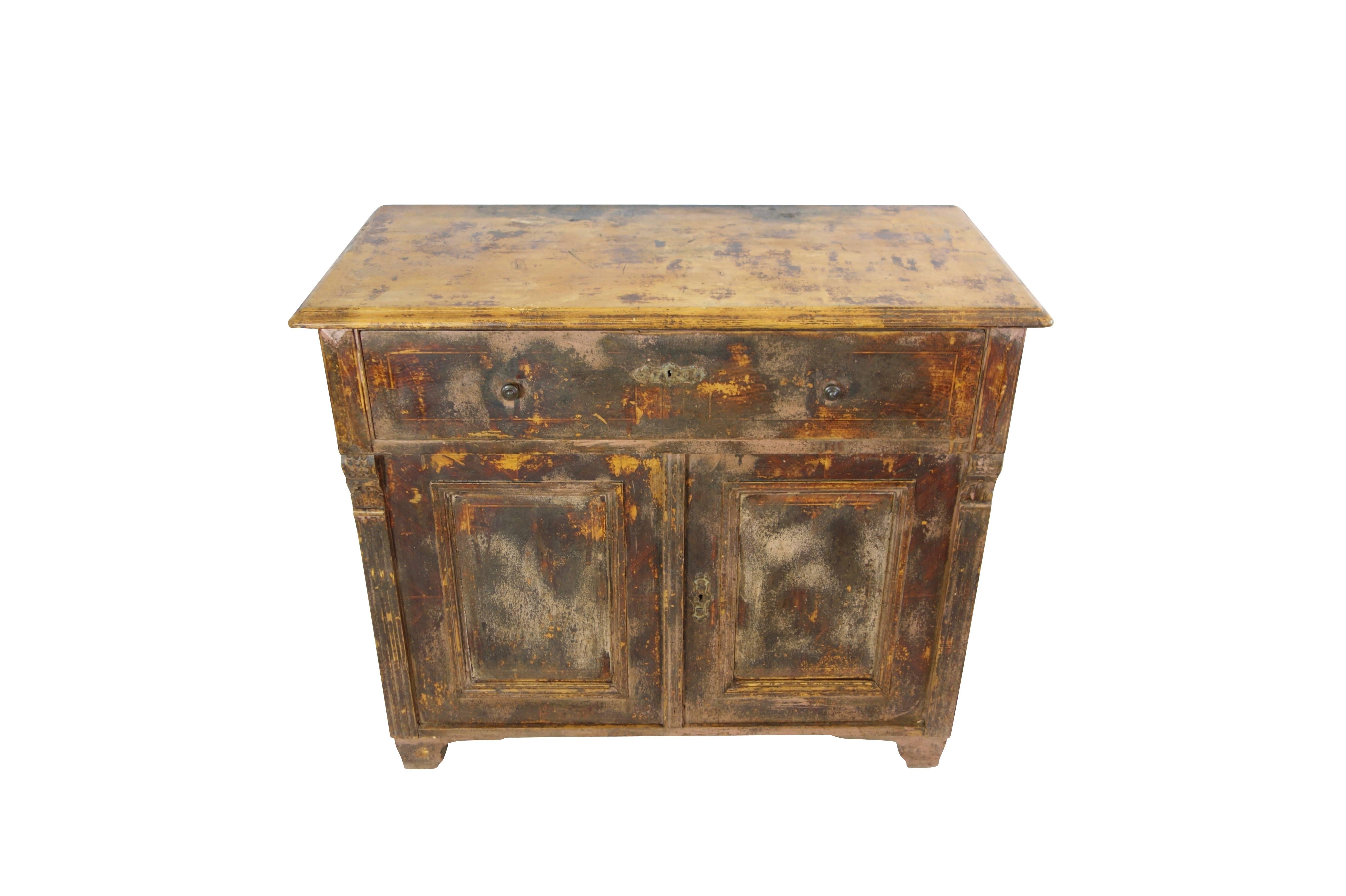 This is an early 20th century pine dresser from France with several layers of paint from over the years and all original knobs and hardware.