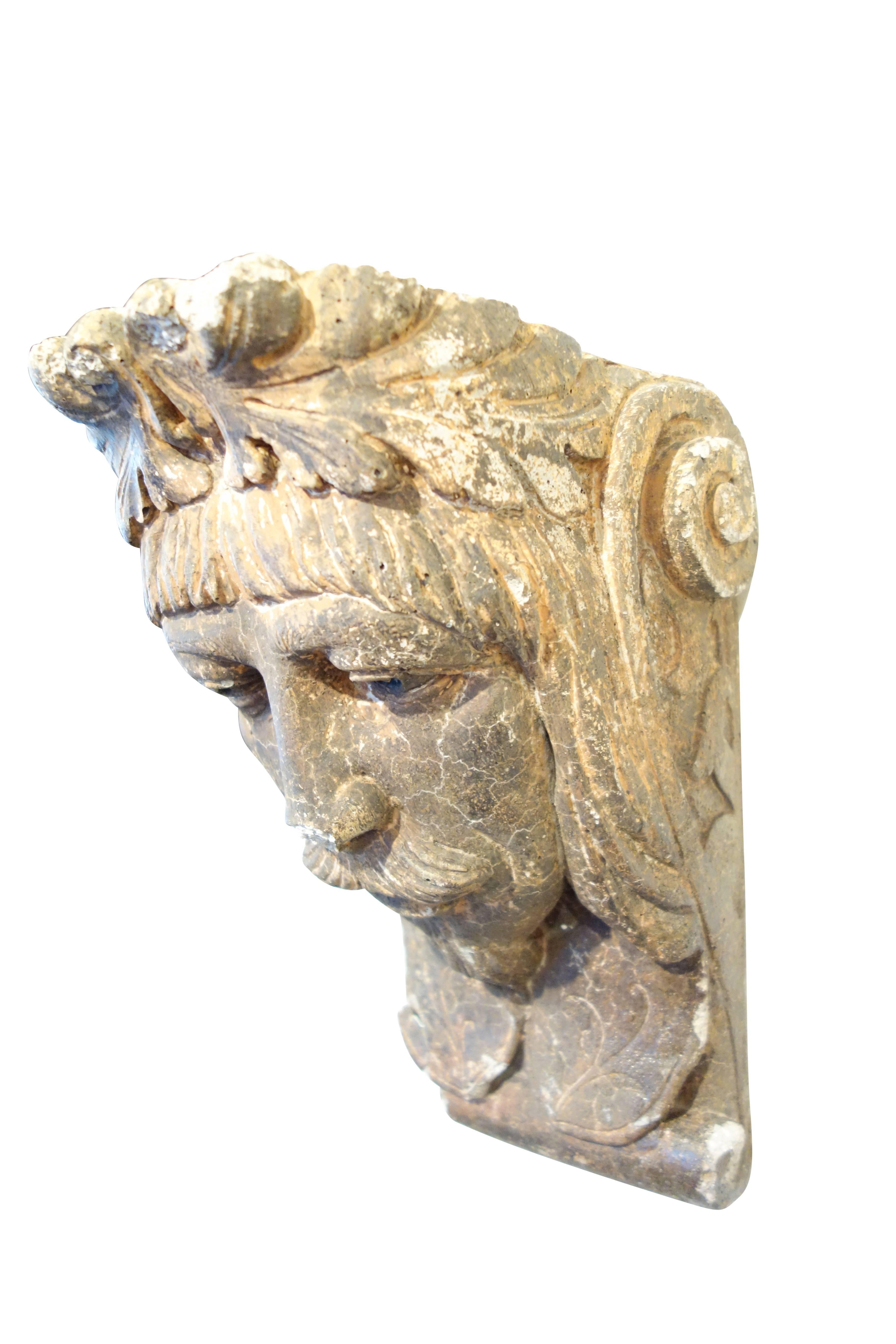 This is a hauntingly beautiful pair of plaster corbels in the form of a man and woman's face. The female resembles a gypsy, wearing a headscarf with a leaf pendant on her forehead. The male is sporting a mustache, goatee, and nicely trimmed bangs.
