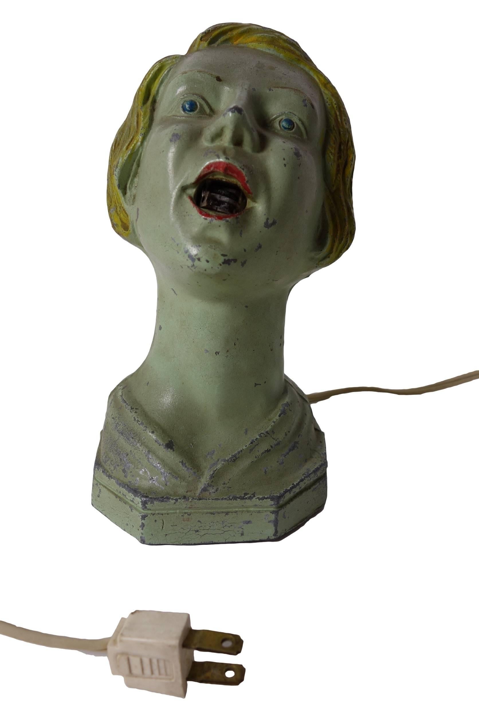 This table cigarette lighter by Arturo Levi is an Art Deco piece from the Frankart era and is certainly a conversation starter.  She has her original paint and is made of cast spelter.  On the inside of her mouth is an electric heating element that