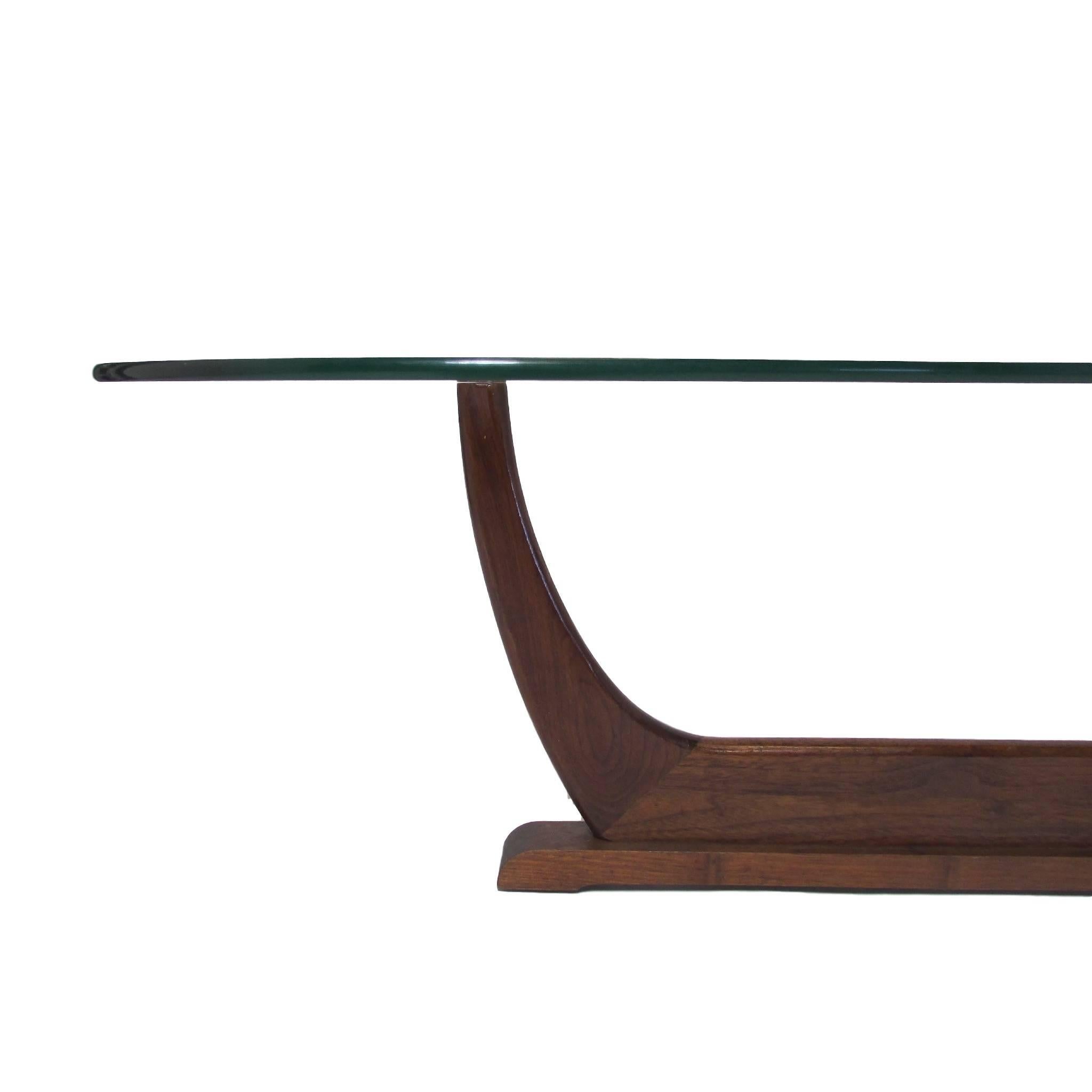 Unusual teak mid century modern tripod coffee table with a thick piece of kidney shaped glass.  