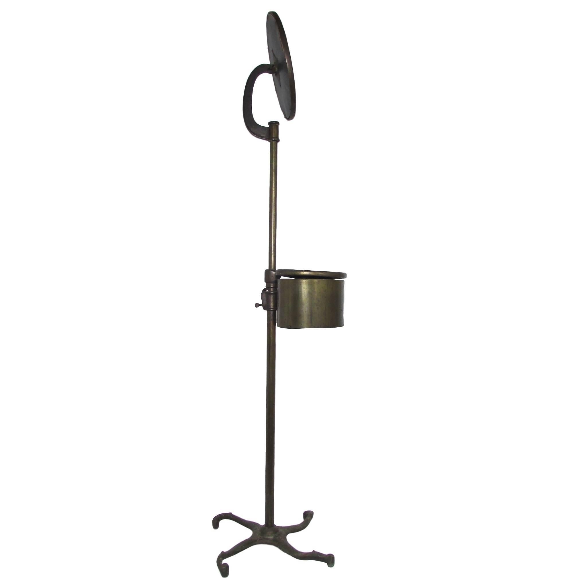This is a lovely brass and cast iron Victorian era shaving stand set on casters.  Fully adjustable in height, this piece still serves a purpose in the modern day home.  It has a storage compartment with a pivoting lid to stash away toiletries.  