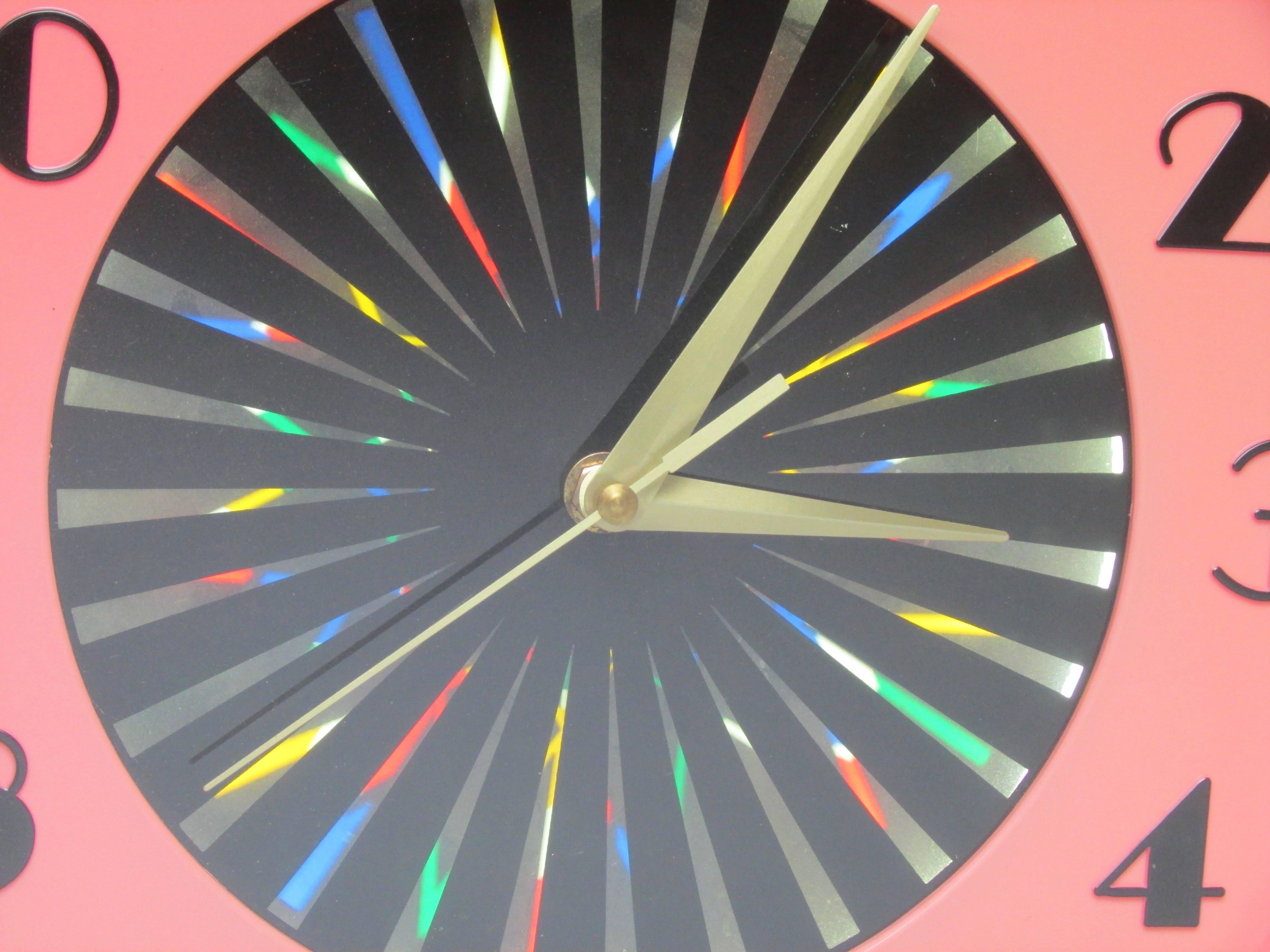 This is a fantastic retro kaleidoscope wall clock with a psychedelic spinning color wheel in the center, circa 1950.