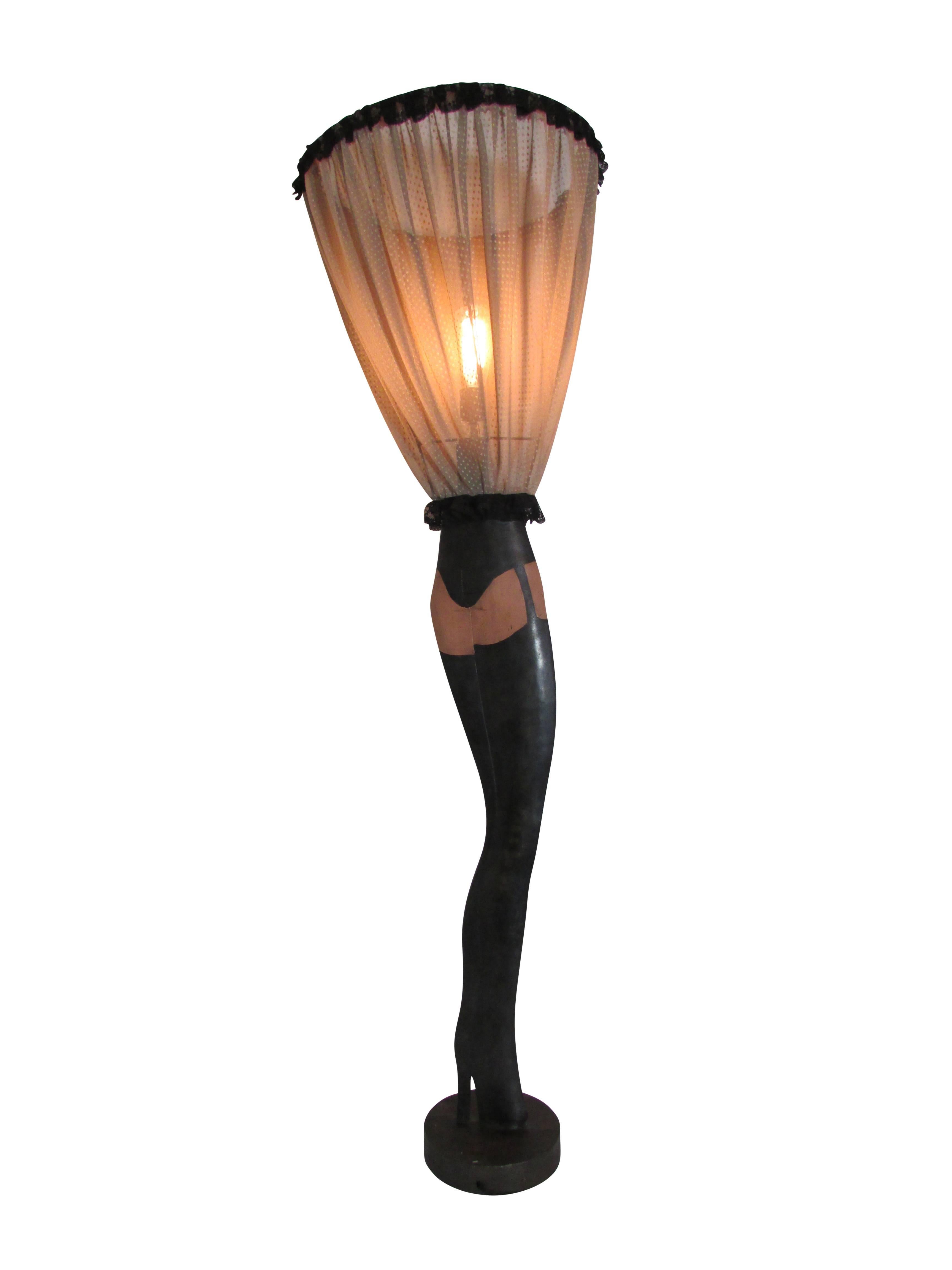 This is a fantastic double-sided floor lamp in the form of a woman's legs, with the original lampshade as her blown up skirt. Made of sculpted steel, then cleverly painted with thigh high stockings complete with garter and panties. Oh là là!!