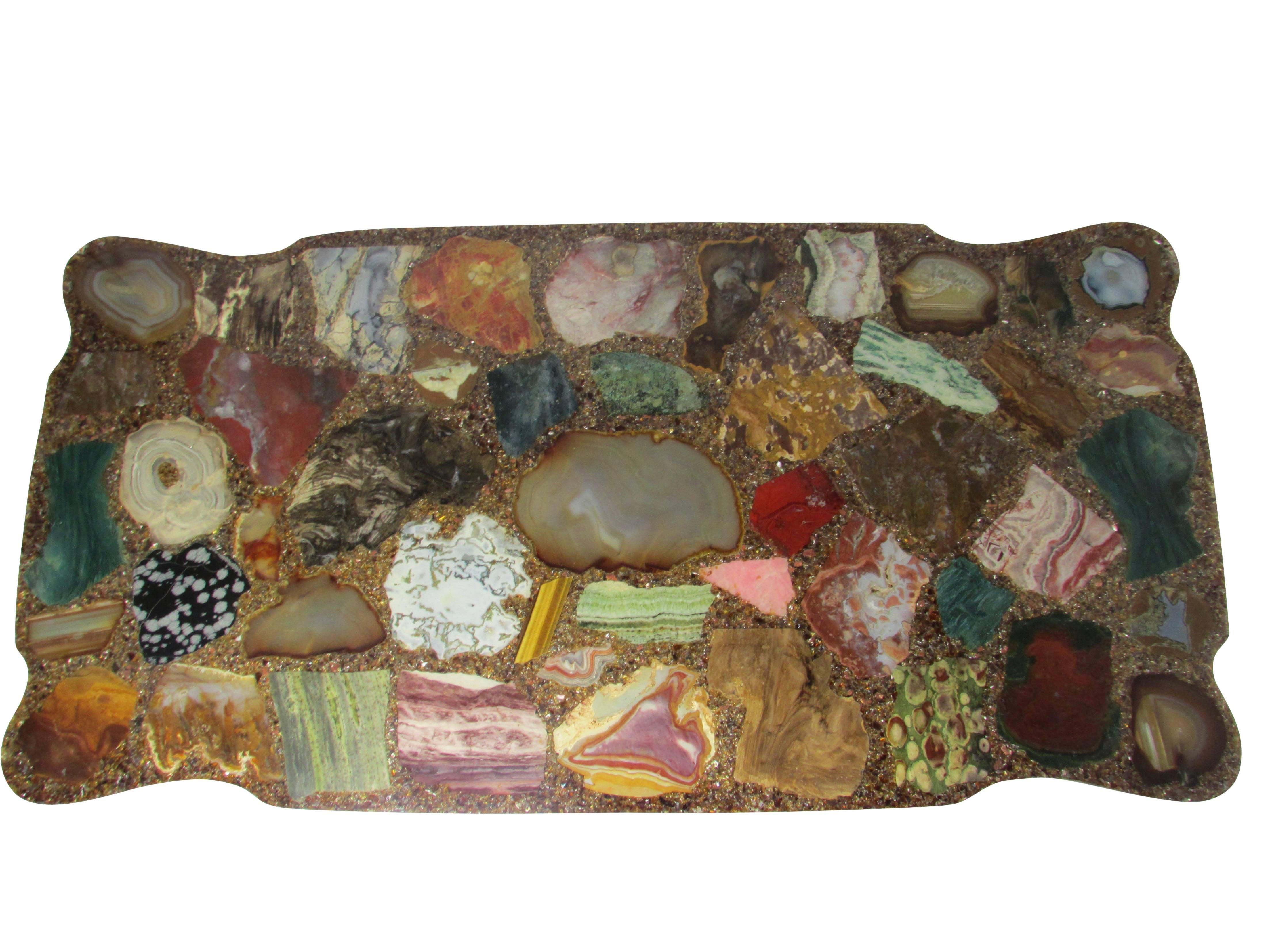This is a unique Midcentury poured resin coffee table with an array of sliced geodes comprising the top.
