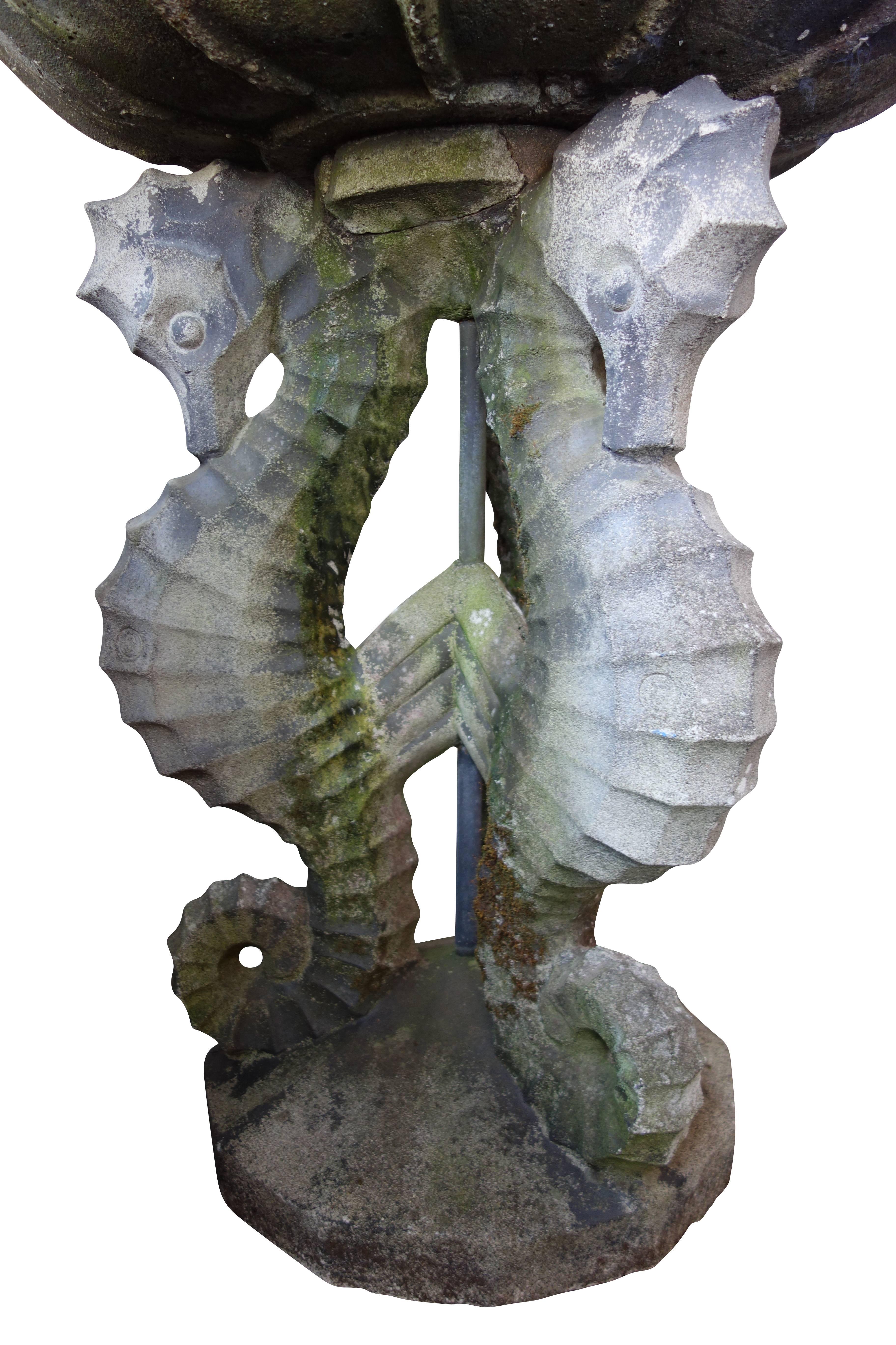 This is a beautiful moss covered concrete birdbath with three figural seahorses for the base.