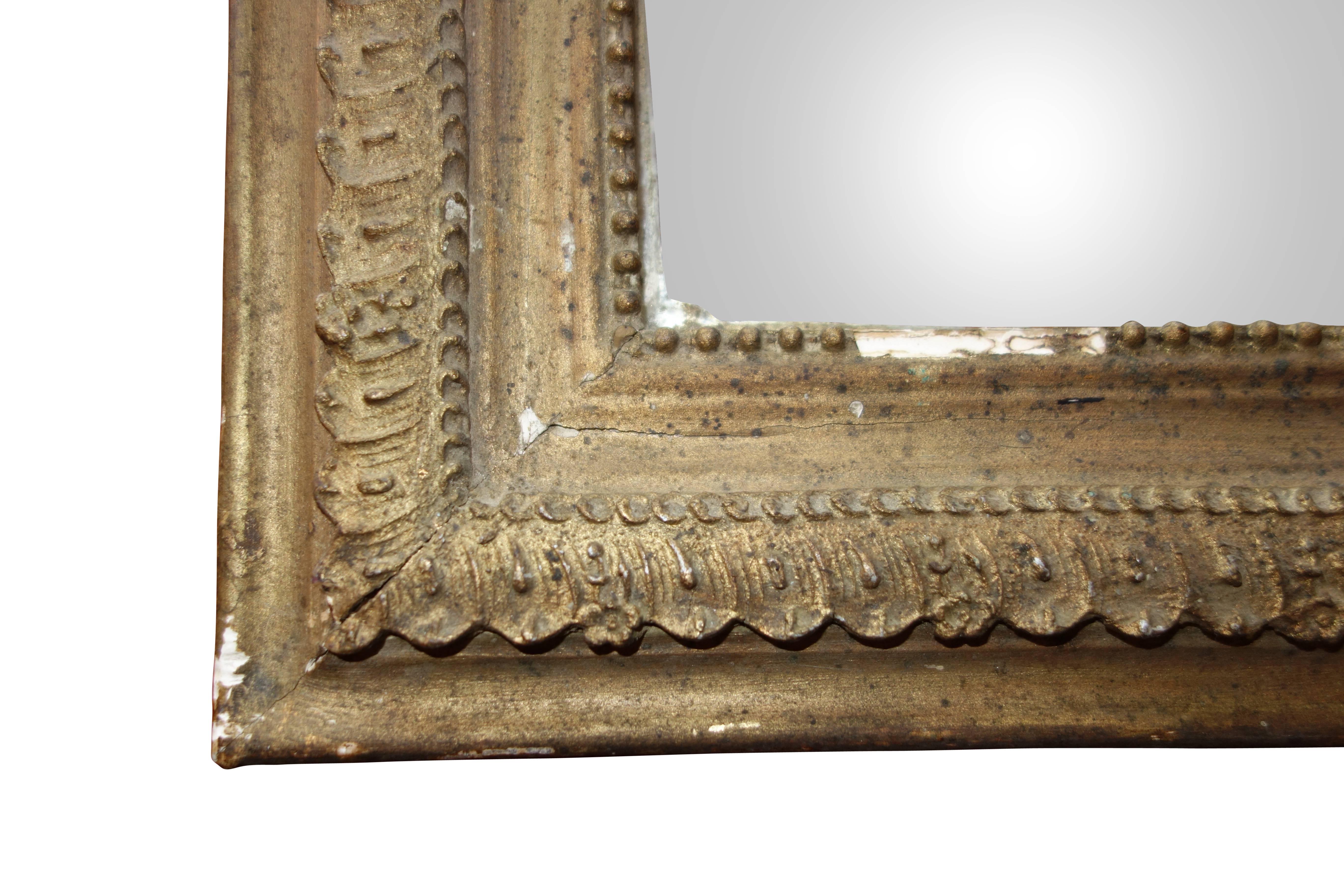 This is a small turn of the century gold framed mirror from France.