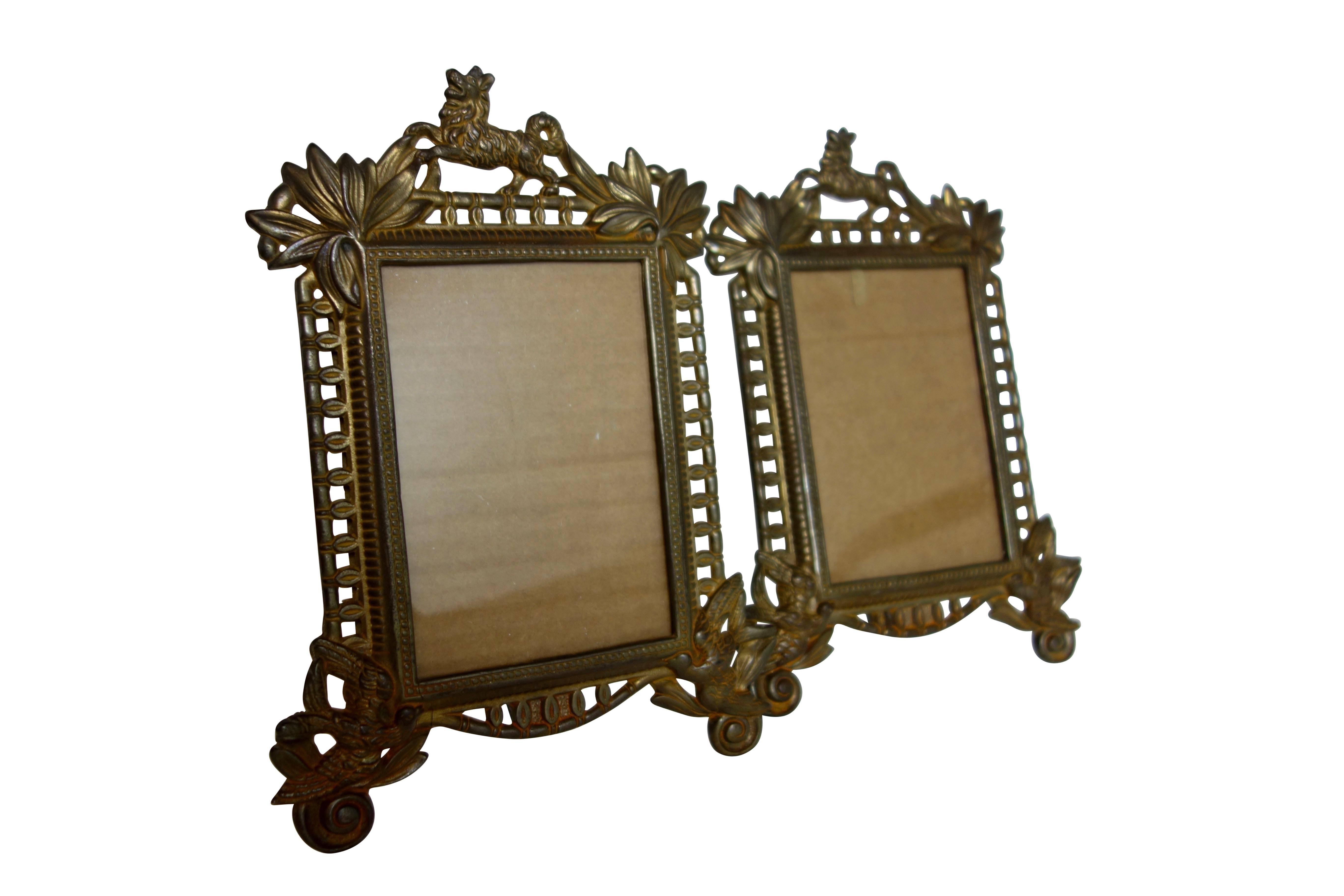 This is a pair of 19th century French gilt frames with dogs and birds. On the back there's a makers mark stamped 