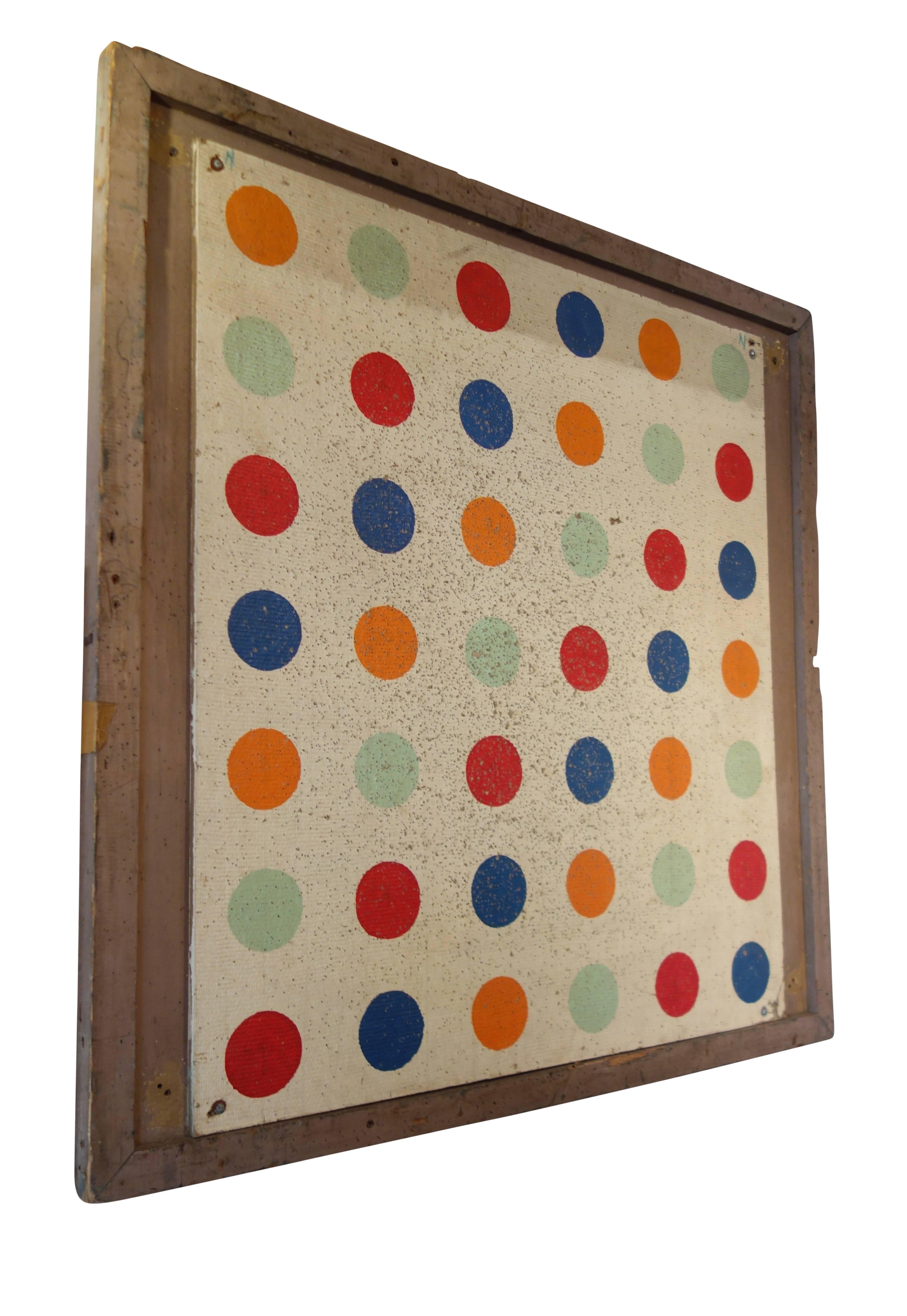 This is a balloon dart board panel on its original painted wood frame from a carnival in Riverside Park, Wisconsin, circa 1920. The brightly colored polka dots give it a modern pop art feel. There is a slightly smaller pair to this panel, see other