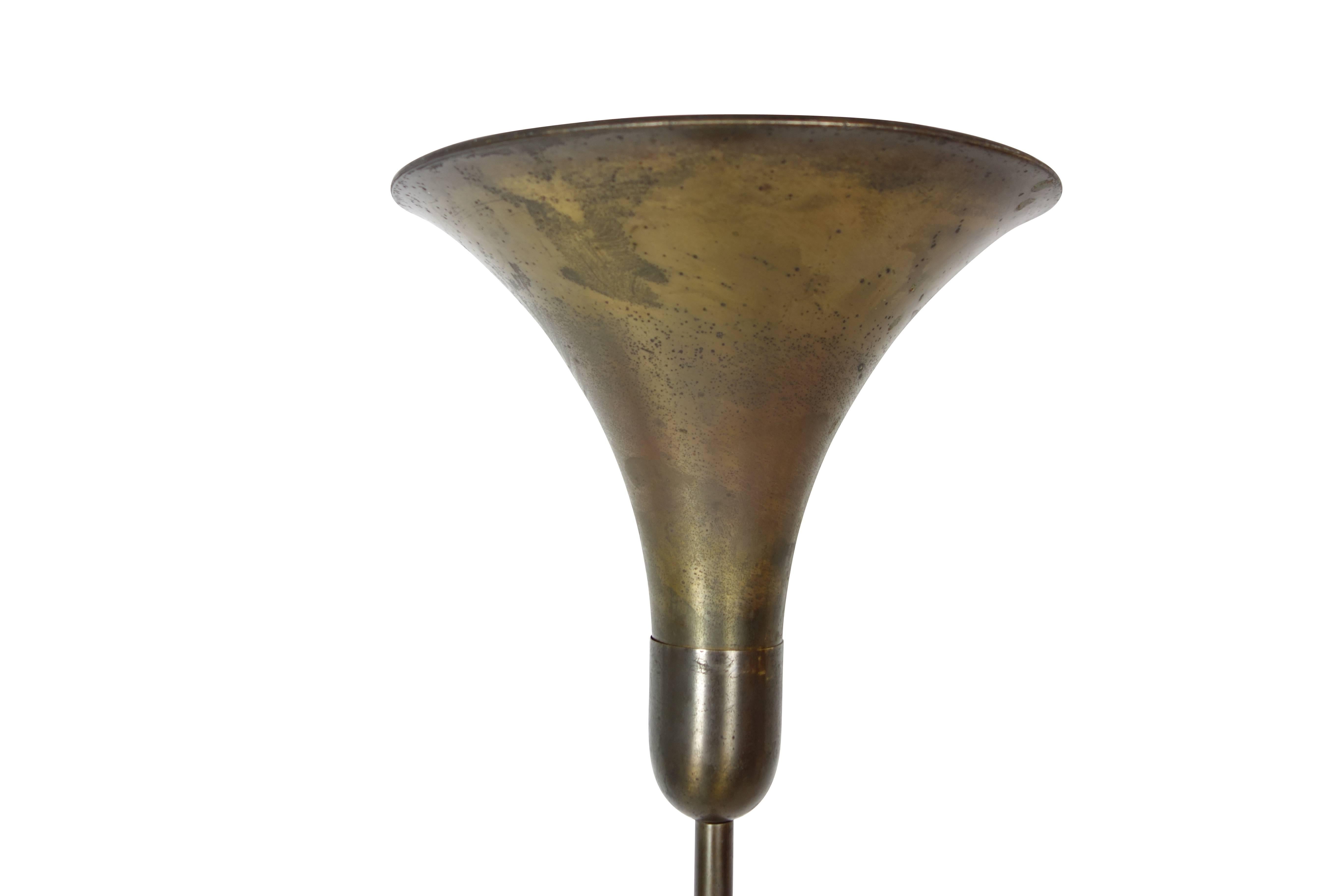 This is a brass torchiere floor lamp, circa 1940. We have two available.