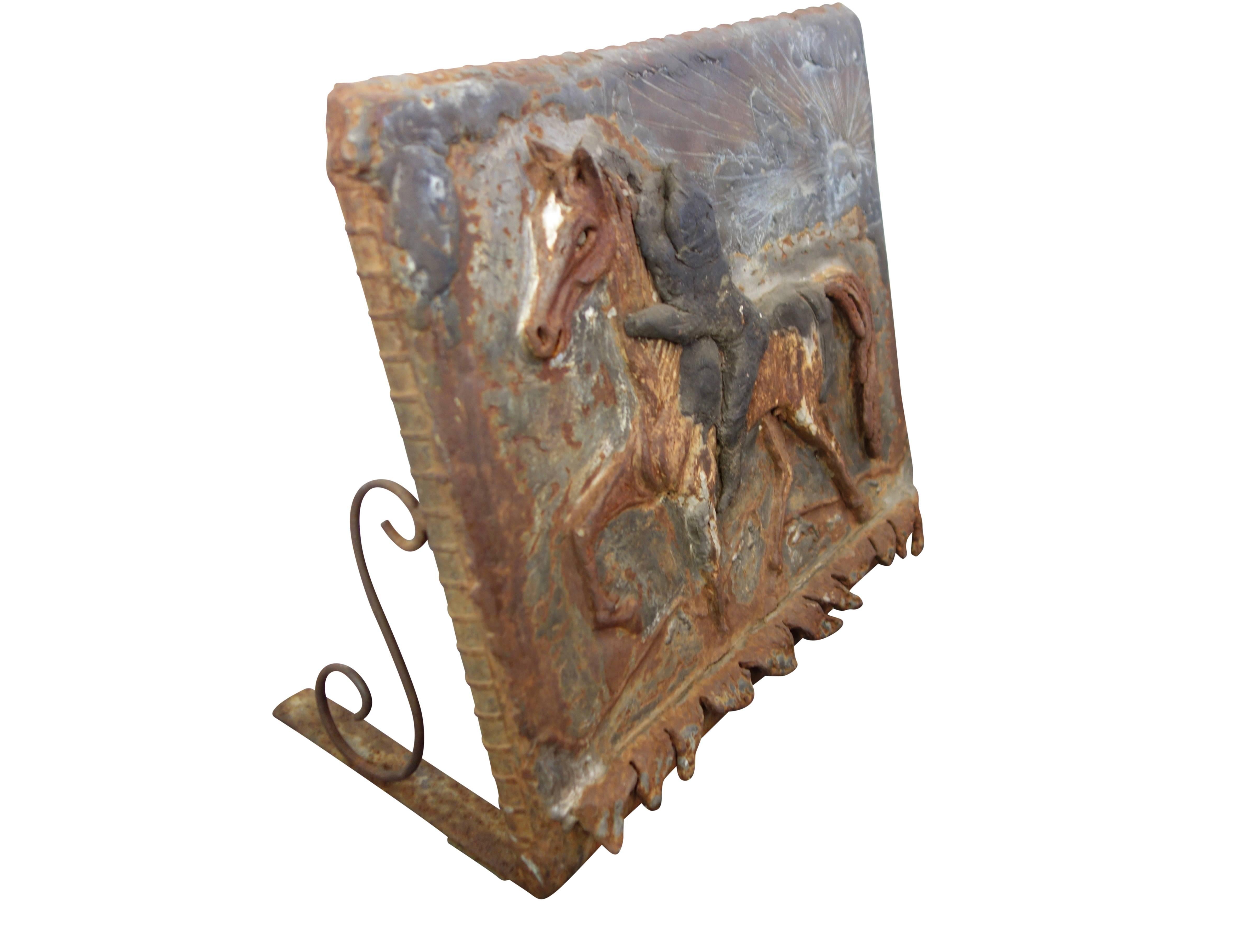 This is a one of a kind cast iron and copper plaque of a horse and rider. The sun and sky portion of the plaque is made of copper. Written on the back of the copper piece is 