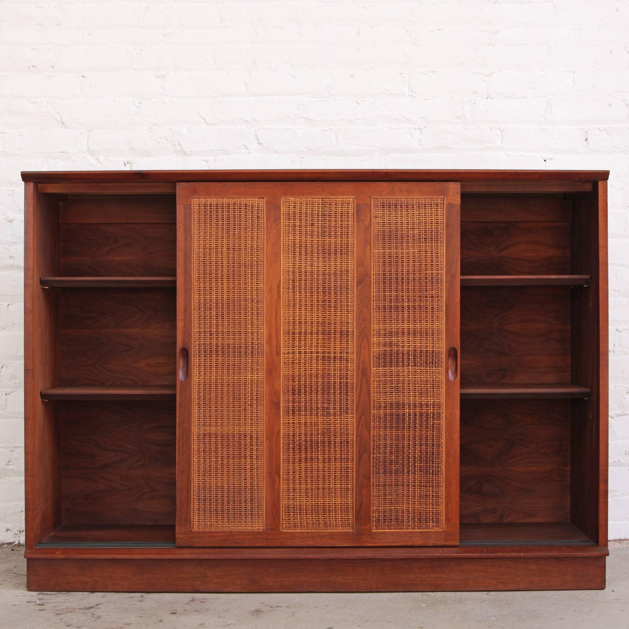 Stunning mahogany and cane sideboard or cabinet by Harvey Probber. Four interior adjustable shelves.