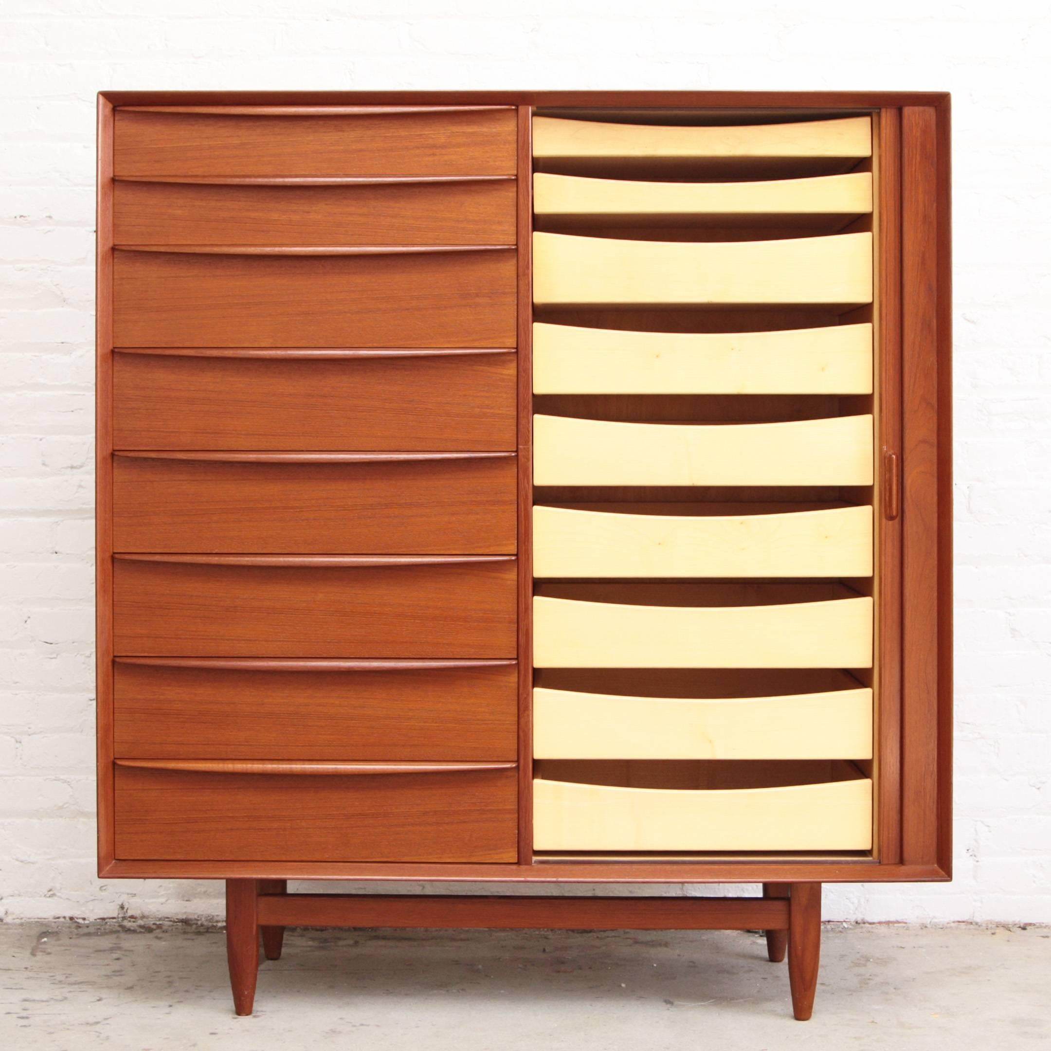Svend Madsen for Falster tall chest of drawers, made in Denmark. Teak exterior, sculpted drawer pulls and tambour door. Blonde birch interior drawers.