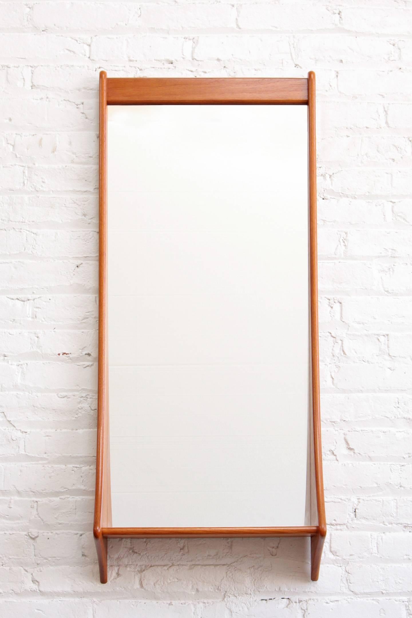 Danish modern wall hung mirror with shelf. Made by Pedersen and Hansen, Denmark.