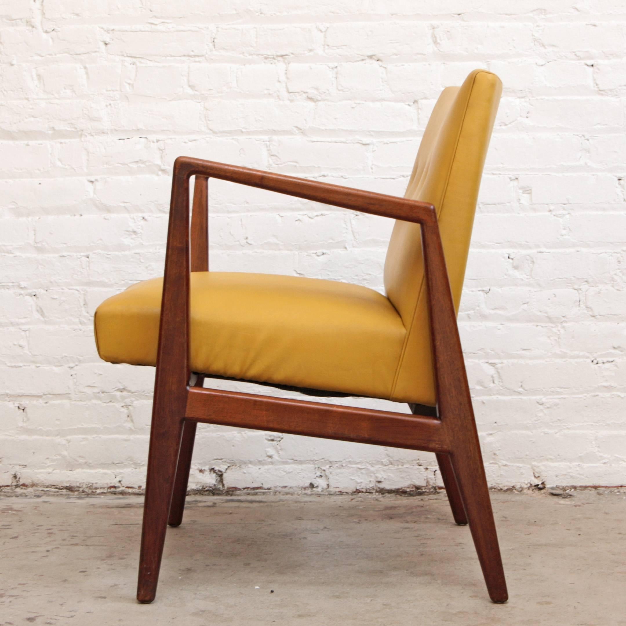 Lounge chair or armchair by Jens Risom. Solid walnut sculpted frame with mustard yellow vinyl upholstery. Compact design with great lines!