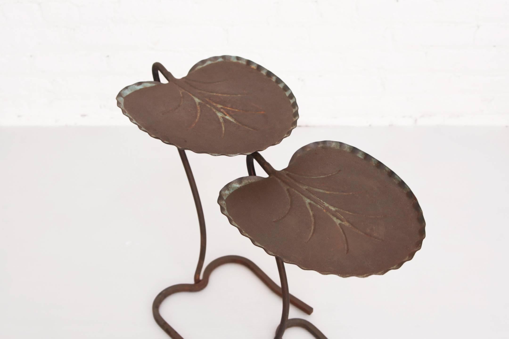 Two wrought iron metal lily pad cantilever tables designed by John Salterini. One is larger that the other and they nest together.

Measures: Large: 13.5