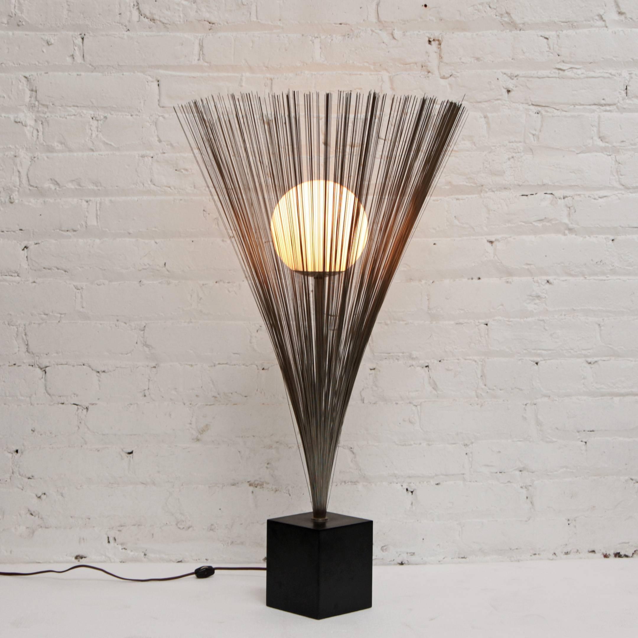 Mid-Century Modern table lamp by Laurel. In the style of Bertoia's spray sculptures. Metal wire encircles a glass globe.