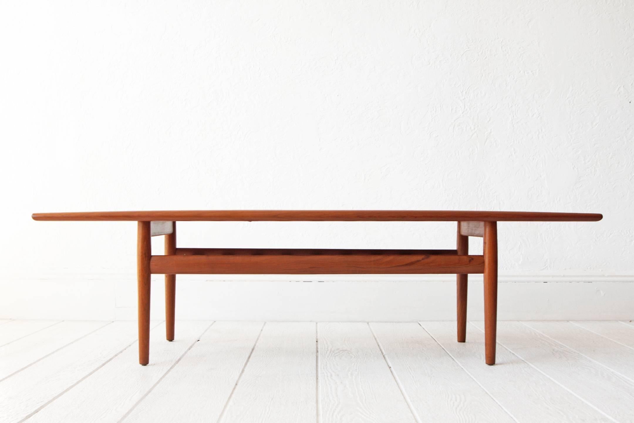Two tier teak coffee table by Grete Jalk, Denmark. The second tier is perfect for storage / magazine rack. Sculpted wood lip. 