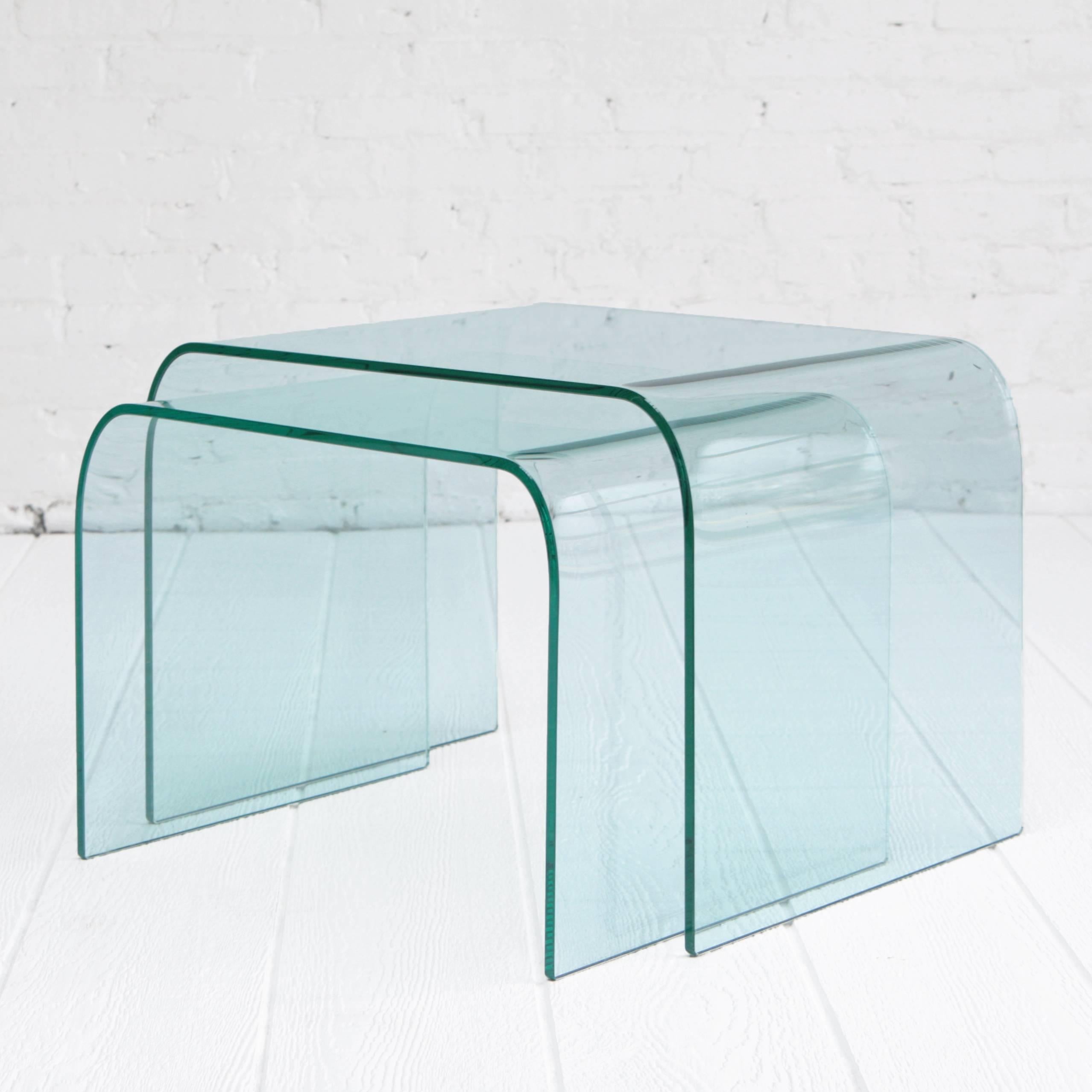 Molded glass nesting tables by Angelo Cortesi, made in Italy. They nest together and can be used in so many ways. When pulled apart they make a beautiful layered effect. The glass is tempered and the edges are beveled.