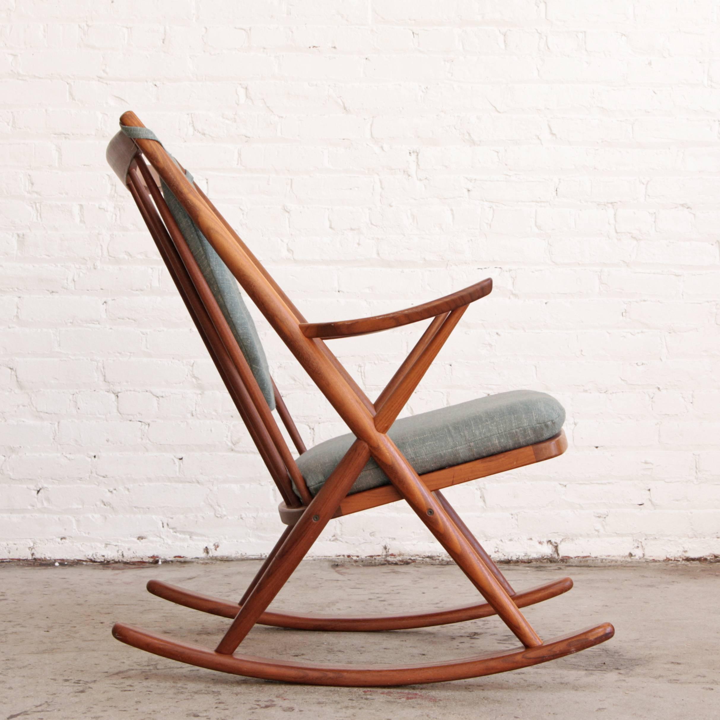 Solid teak rocking chair designed by Frank Reenskaug for Bramin Mobler in 1958, made in Denmark. New blue / grey and cream cushions.