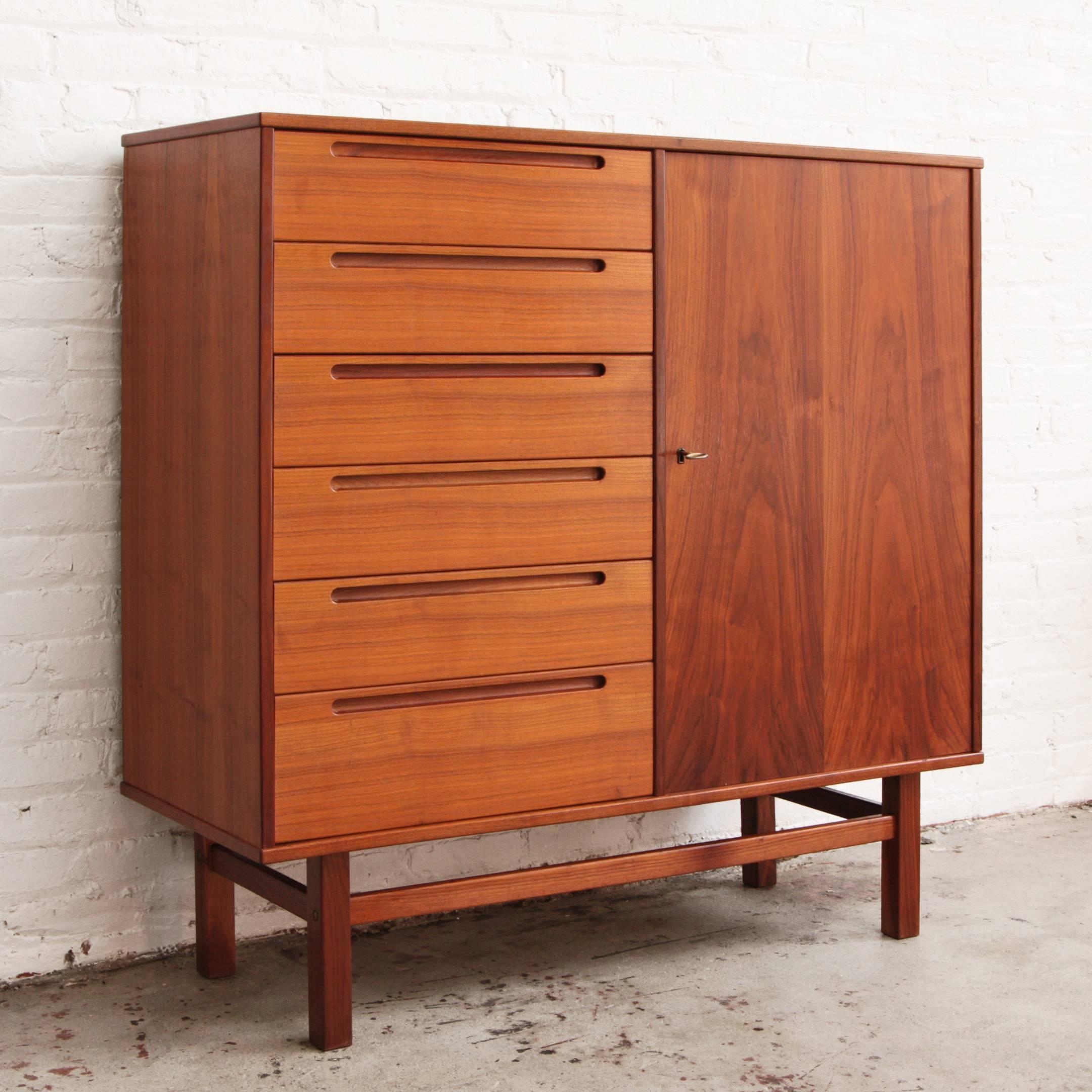 Nils Jonsson for HJN Mobler teak tallboy or chest of drawers. Six large drawers and six thin blonde interior drawers. Locks with key.