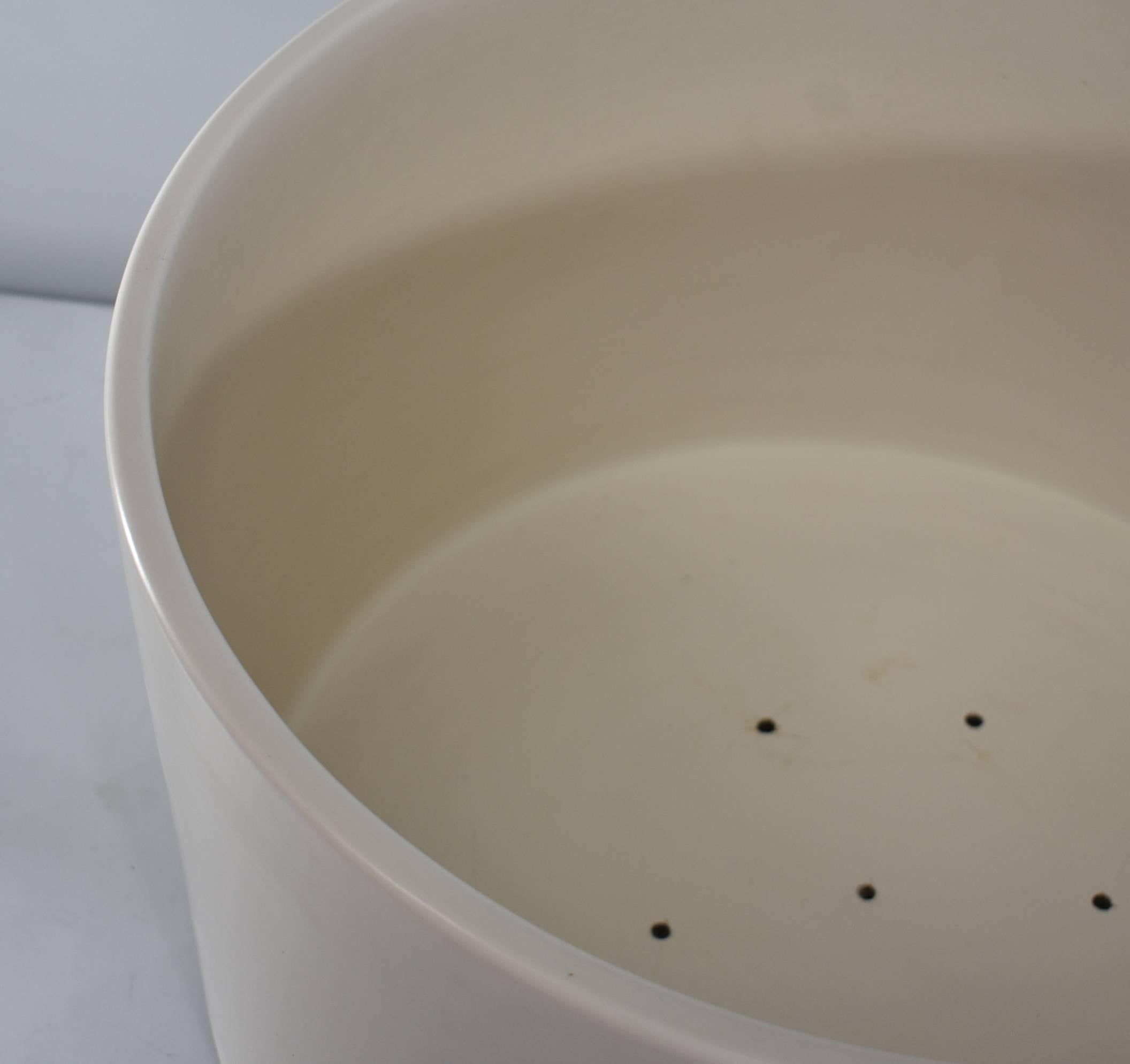 Large oversized matte cream ceramic planter in the style of Gainy. Drain holes have been drilled in the bottom. Very heavy. A few small pin holes in the glaze.