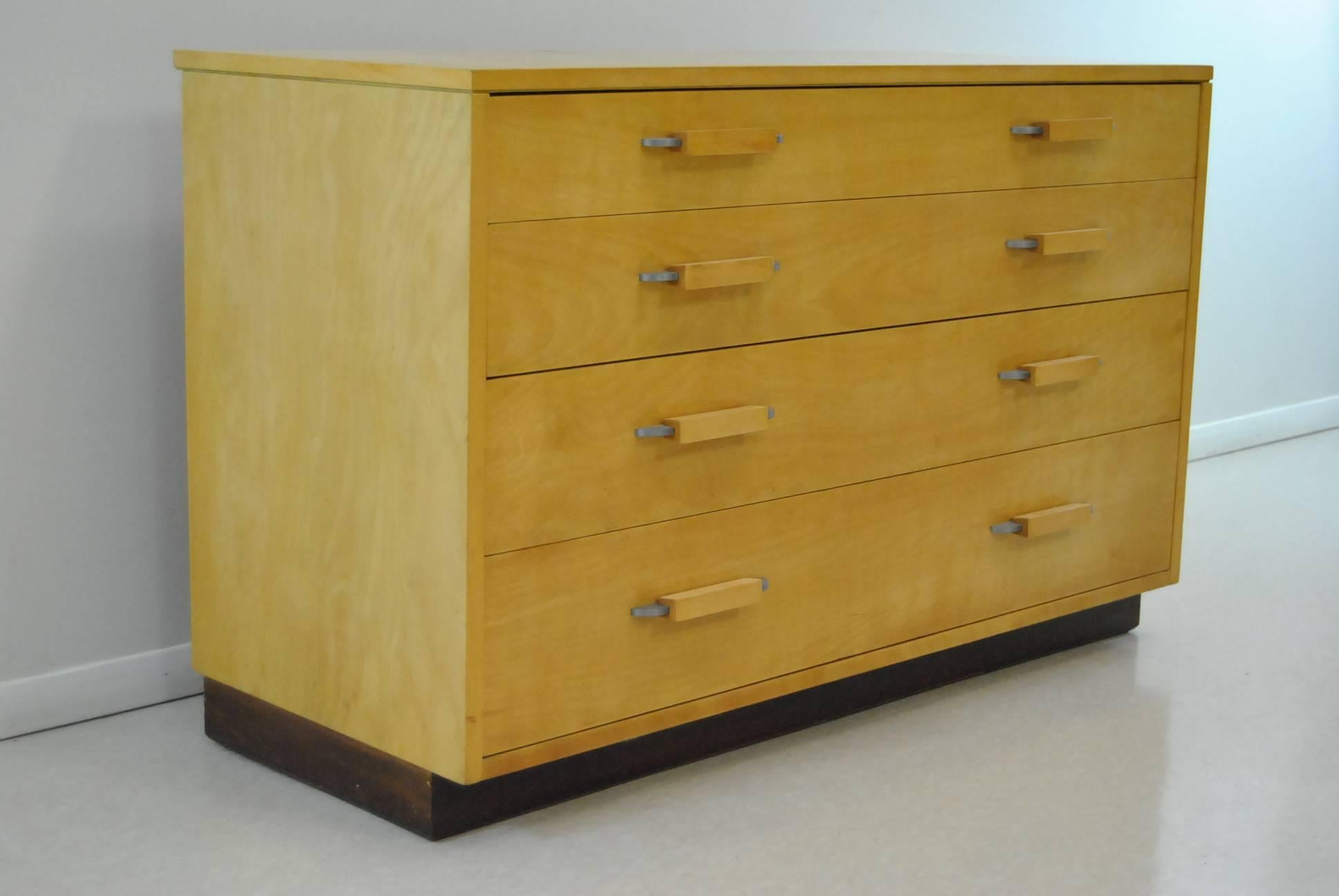 Light birch four-drawer chest by Johnson Furniture Company Grand Rapids Michigan by designer Eilel Saarinen. Original finish and hardware. Overall good pre owned condition. One minor repair to corner of drawer as shown in photo. 