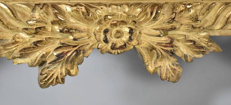 Beautifully carved French style mirror with a washed gilded finish by John Richard. Floral details and a rope border design accent add formal appeal. Very nice pre owned condition.