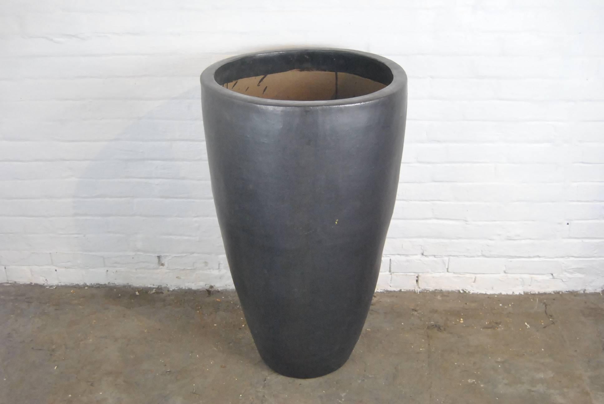 A pair of architectural Asian style indoor / outdoor matte glazed gunmetal planter. 
 Very large-scale. Good condition with rustic imperfections in the glaze that adds to the character. Very heavy. Measures: 38" tall x 22" in diameter.