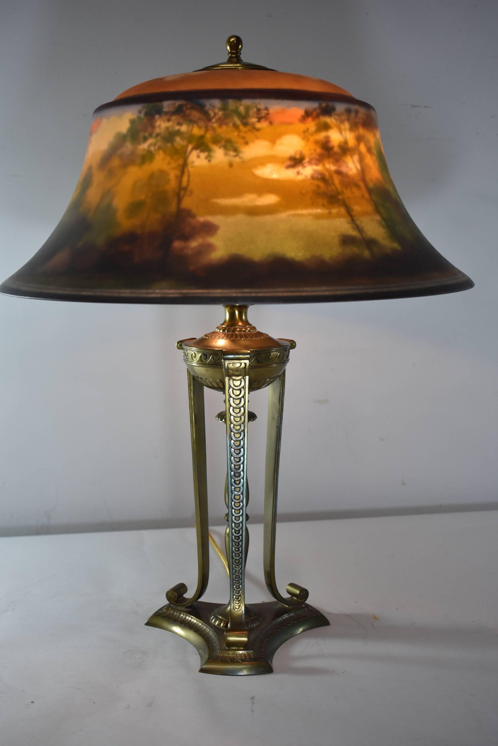 Pairpoint reverse painted table lamp #D307. Exeter shade signed L.H.Gorham. Beautifully depicted landscape. No chips or repairs to the shade. Base is original with a bronze tone finish. Lamp has been rewired.
