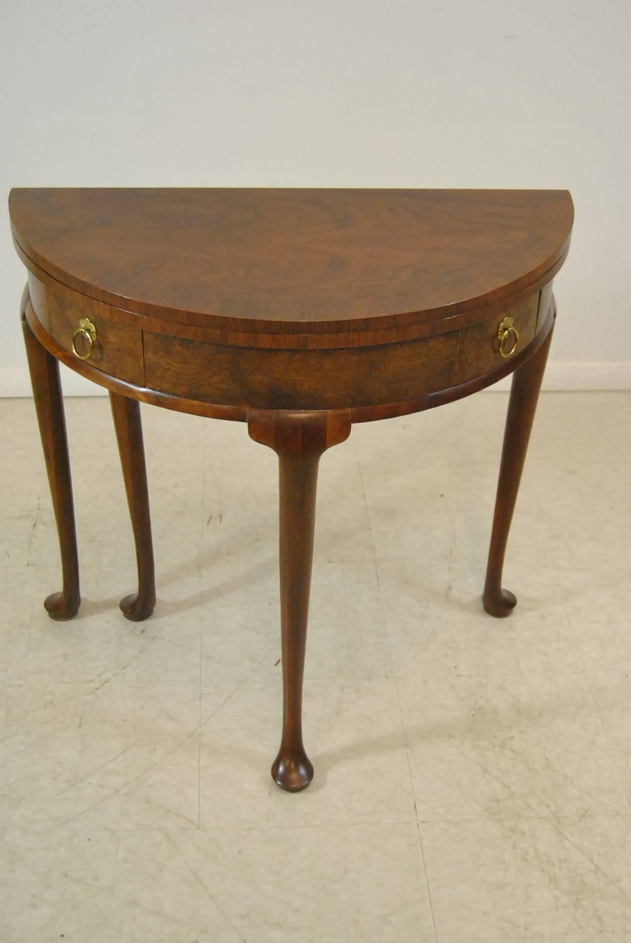 Georgian style demilune game table by Baker Furniture Company. Beautiful banded flip-top. Two dove tailed drawers have brass hardware. Very good pre owned condition with light wear from age and use.